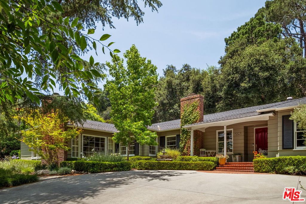 Tucked into the prestigious Linda Vista neighborhood of Pasadena, this beautifully updated single-level residence blends timeless design with luxurious finishes in a private setting framed by mature trees and lush landscaping. Inside, hardwood floors and soft natural light create a warm, welcoming atmosphere. A formal living room with a classic fireplace and French doors opens gracefully to the tranquil backyard, creating a seamless connection to the outdoors. The chef's kitchen is both elegant and functional, featuring a generous center island, professional-grade appliances, a farmhouse sink, walk-in pantry, and a charming breakfast nook framed by garden views. It is perfectly designed for both everyday living and entertaining. The family room offers a second fireplace, built-in speakers, and an adjacent powder room that makes hosting effortless. A formal dining room and dedicated office or playroom provide added flexibility for work and gatherings. All four bedrooms are located in a separate wing to ensure comfort and privacy. The expansive primary suite serves as a private retreat with a sitting area, fireplace, and a spacious walk-in closet. The spa-like bath features a soaking tub, oversized shower, dual vanities, and a skylight that fills the space with natural light. Three additional bedrooms and two well-appointed bathrooms complete the private wing, offering space for family and guests. Outdoors, the property unfolds as a true sanctuary. Set on a large, private lot, the grounds feature winding stone paths, vibrant landscaping, and towering trees that create a natural canopy overhead. A koi pond with a gentle waterfall adds a sense of calm throughout the outdoor space. The oversized in-ground spa is nestled beneath the trees, offering a perfect place to relax. A covered patio and built-in gas BBQ make entertaining effortless, whether hosting intimate dinners or weekend gatherings. On the upper tier of the lot is a detached custom-built structure that provides a flexible space for a home office, art studio, or creative retreat. The front yard also offers a flat, grassy area that is perfect for lounging, outdoor play, or enjoying time with your family under the shade of mature trees. This outdoor environment has it all: privacy, beauty, and a tranquil atmosphere that elevates everyday living. A rare opportunity to enjoy refined living in one of Pasadena's most picturesque neighborhoods, close to a number of renowned schools, the Rose Bowl, and Brookside Park.