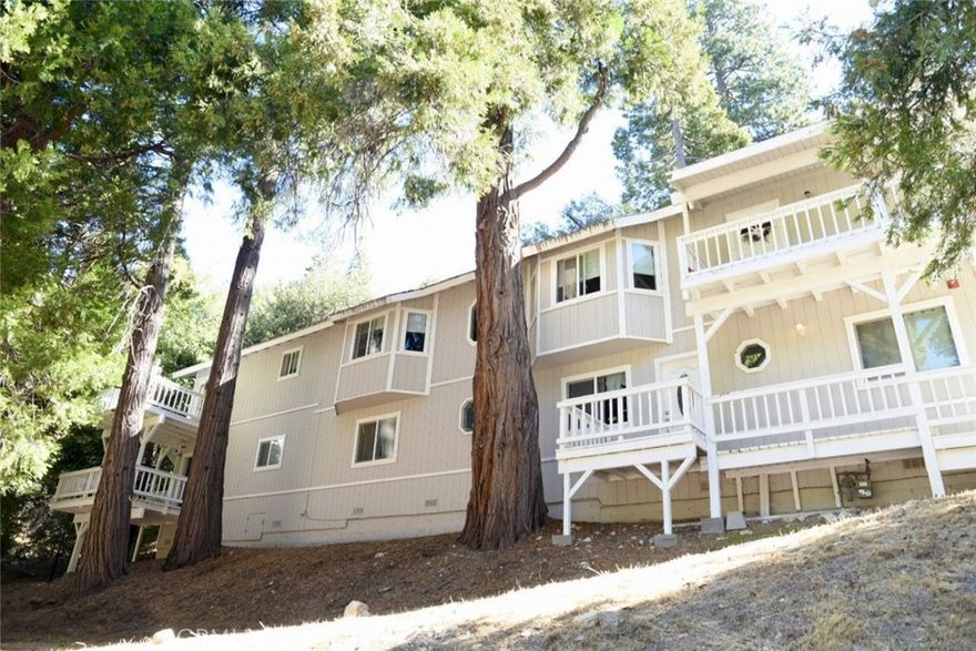 Welcome to this beautifully updated Crestline property featuring both a spacious main home and a fully renovated attached ADU/in-law suite, perfect for multi-generational living or income potential.



The main home offers approximately 1,918 sq. ft. with 3 bedrooms, each featuring its own walk-in closet, and 2 bathrooms. The primary suite is generously sized to accommodate a king bed and sofa, complete with a large walk-in closet and en-suite bathroom. The kitchen has been upgraded with quartz countertops and opens seamlessly to the living room, highlighted by a cozy fireplace. Additional features include an indoor laundry room and numerous updates within the last 7 years, including dual-pane windows, refreshed bathrooms and kitchens, new flooring, interior paint, and a new main water line.



The attached ADU/in-law suite spans approximately 1,280 sq. ft. with 2 bedrooms and 2 bathrooms. Its open-concept kitchen features a large island, updated stainless steel range, microwave, and dishwasher, and flows into the living area. The primary suite boasts two large double closets, an en-suite bath, and access to a private walk-out deck. This unit also includes indoor laundry.



The property sits on a large lot with a concrete and asphalt pull-through driveway, providing ample parking and convenience.