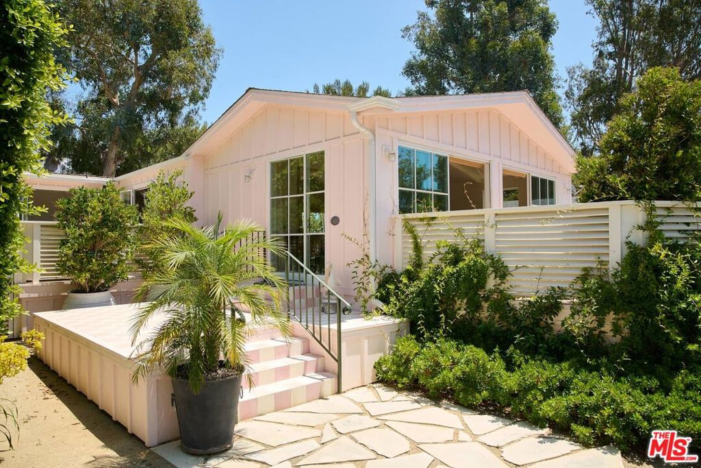 Completely bespoke and architecturally designed beach home in the ultra-exclusive bluff section of Paradise Cove, just steps from one of the country's most iconic and picturesque beaches. Step through the stylish checkerboard-tiled entry of this beautifully crafted new build into a high-ceilinged living/dining space with hardwood pine floors, fabulous built-ins, a spacious breakfast nook, and Domingue Atelier steel sliders that open directly onto an expansive patio with plenty of room for entertaining or relaxing. Enjoy a cocktail at the built-in bar before preparing dinner in the striking, modern chef's kitchen with Fisher Paykel appliances, AGA oven and separate drinks fridge. Additional sliders open from the kitchen and dining room onto a second large, super-private outdoor space. The well-appointed bedrooms feature lovely built-in cabinetry and en-suite bathrooms, each with their own uniquely charming elements, from bold Pierre Frey & Schumacher wallpaper to incredible Cle tiles and Water Monopoly fixtures- and an absolutely jaw-dropping freestanding designer tub. The primary suite offers a walk-in closet as well as French doors opening onto yet another private outdoor area. The completely private guest suite has its own entrance, spacious built-ins, dual full-size Murphy beds, a bathroom with incredible custom tiling, and plenty of space for use as a studio, gym, or ADU. Additional bonuses include parking for 3 cars and extra space for a golf cart. Residents of Paradise Cove enjoy exceptional amenities including gated security, a playground for the kids, tennis and basketball courts, a clubhouse for social gatherings, and of course direct access to stunning Paradise Cove Beach. With plenty of fantastic restaurants, shops, and schools just minutes away, this is your opportunity to own your dream house by the sea.