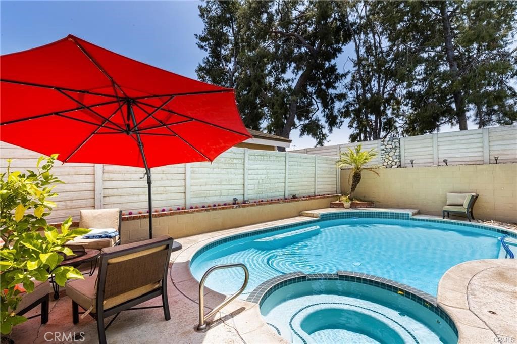 Beautiful Single story 3-bedroom 2-bath Woodbridge Condo (Inside the Loop!) with its own private swimming pool! This beautifully updated end-unit is truly a rare find here in Irvine! The kitchen has granite counters and stainless steel appliances. The entrance, kitchen, and baths are all tiled in gorgeous Travertine. The rest of the floors are all finished with stunning engineered wood. Double-paned windows are covered with spectacular Combi electronic window treatments and white plantation shutters. Master has a walk-in closet and sunny, en-suite bath complete with a large spa tub - fantastic for reading-in. The garage has new Epoxy floors and lots of cabinets. The sparkling pool has just been redone - new motor, pump, skimmer, and sealant! Hang out in the living room by the fire or have a drink by the pool - the choice is yours! In addition, Woodbridge amenities include 2 lakes with private beaches, 24 tennis courts, 22 pools, parks, and all kinds of sports courts including pickleball! Don't miss out on this fabulous home!