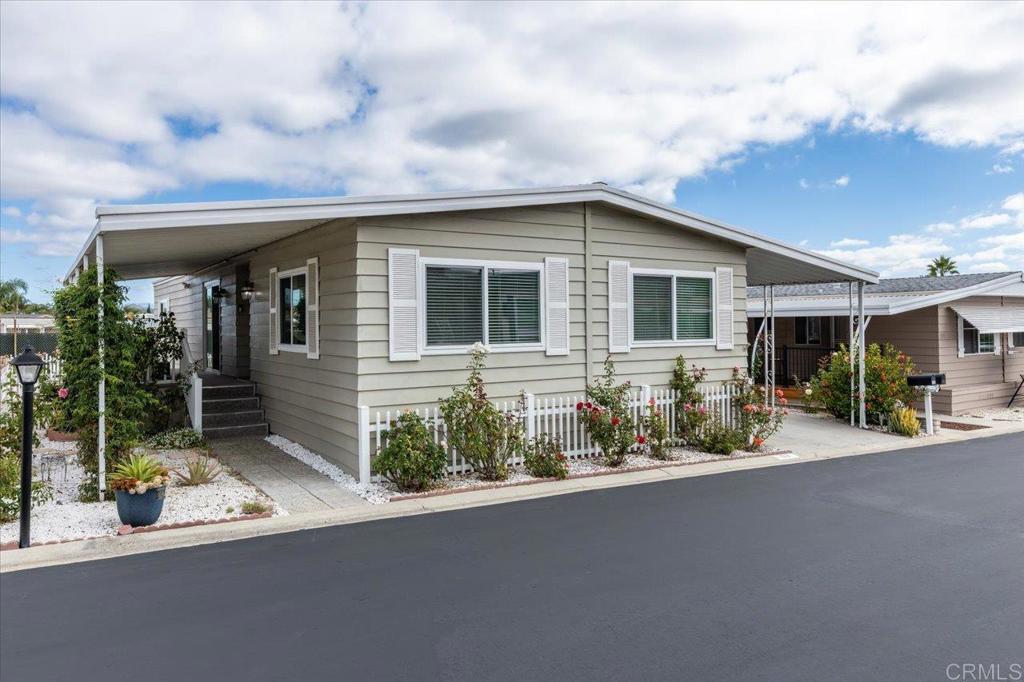 Lovely and unique remodeled 2 bed / 2 bath located in a 55+ rent controlled park with NO property taxes (home is still on HCD registration). Tucked away on a cul-de-sac near the Tennis Courts and other amenities, this home boasts a remodeled Kitchen and Bathrooms, vaulted ceilings in the Living room and Dining room, dual pane windows, newer interior doors and fixtures, and a separate office space. The Primary Suite boasts double sinks, a walk in closet, and a spacious custom step in shower. The second Bedroom also has it's own ensuite Bathroom, which is convenient for guests or roommates. The exterior offers a low maintenance yard, private covered porch, a covered carport that can fit multiple vehicles, and a storage shed. Palomar Estates East is a very active and social 5* community - check out the photos to see some of the amenities this community has to offer! Convenient to shopping, restaurants, Lake San Marcos, two golf courses at Lake San Marcos, another golf course nearby off Twin Oaks, entertainment, lots of parks and trails, the San Marcos Senior Center, and just a short 8 mile drive to Carlsbad beaches! Monthly space rent is only $568.61 and is under rent control!