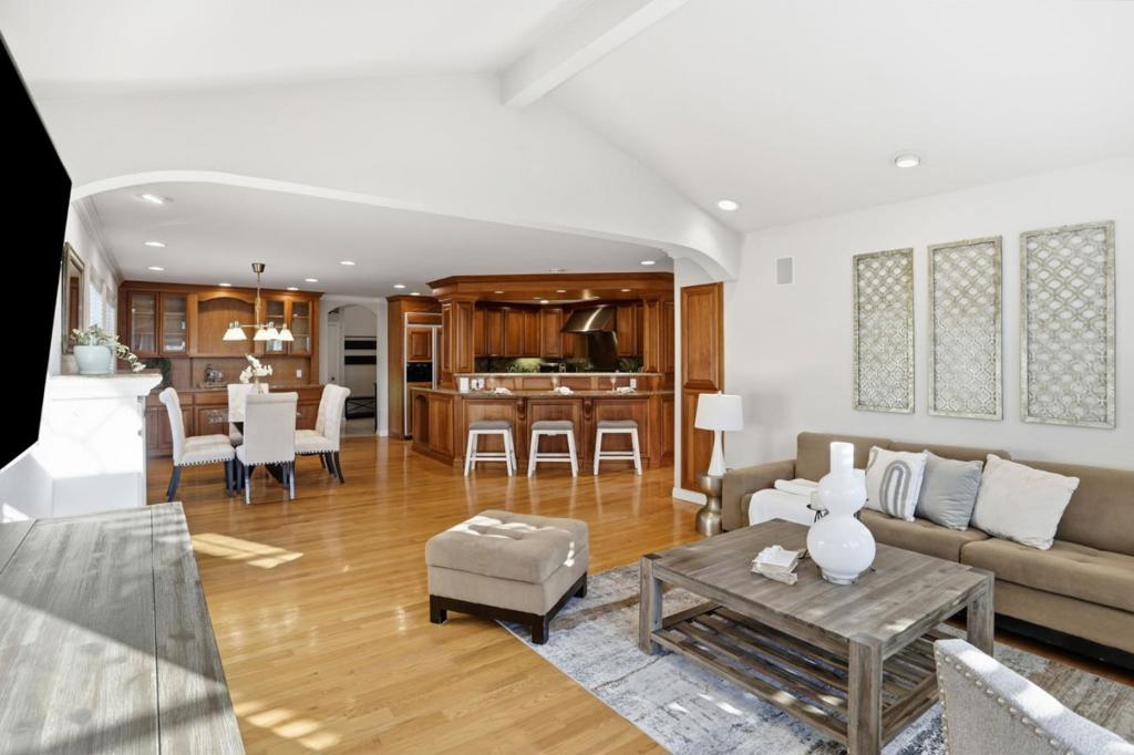 Tucked in a quiet cul de sac shared with only one other home, this 3,000 sq ft 5-bedroom + den retreat sits on a 7,875 sq ft lot backing to the Santa Teresa foothills. The open-concept layout flows from the kitchen with panel refrigerator, stainless steel appliances, island & desk, to the dining area with built-in cabinet, & into the family room with vaulted ceiling. Natural light pours through large windows, illuminating hardwood floors & a warm gas fireplace with mantel. The corner primary suite offers three mirrored closets & an ensuite bath with dual sinks & a step-in shower with bench. Additional spaces include a den with bay window, living room with an extra dining area, & a versatile room off the garage with walk-in closet, ideal as a playroom, workspace, or teen retreat. The brick-paved backyard is built for entertaining with a pool, pool room, outdoor shower, gas fire pit & hillside views. Upgrades include solar, whole house fan, reverse osmosis water filter, water softener & a crawl space moisture barrier system with pump & alarm (2018). Recent updates include remodeled bathrooms (2017-2020), new water heater (2024/2025), pool pump (2025) & automatic pool cover (2021). Located near La Colina Park & Santa Teresa County Park, & served by highly rated Santa Teresa High.