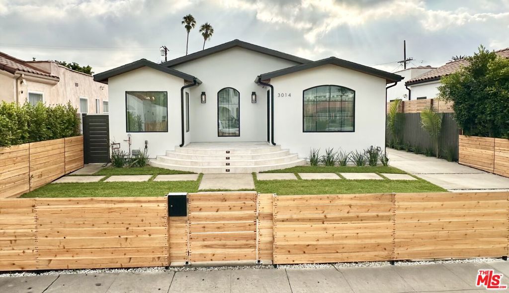Sophistically Designed New Construction Home with an ADU in West Adams! Very spacious, open floor plan with plenty of natural light shining in every room of this 5 bed / 4.5 bath custom home. Everything is brand new and you can be the first to live in this gorgeous Spanish Modern. Just perfect for a family and entertaining as you enter the great room featuring vaulted ceilings, large arched windows, and a custom fireplace. The gourmet kitchen is perfect for any chef featuring a massive island, top of the line Cafe appliances, quartz countertops, and it includes a large food pantry and a butler's pantry as well. Enjoy your tranquil primary suite with 12-foot tall vaulted ceilings, large walk-in closet, and your custom marble bathroom that is more like your private spa retreat as it features a wet room with a free-standing tub to soak in, double-vanity, and sunshine from the skylight above. Comfortably work from home in your bright, in-house office or in your ADU. The ADU possibilities are endless with a full kitchen, private marble bathroom, separate HVAC, and separate electric meter, you can rent it out for $1,700+ per month, use it as a gym, office, mother-in-law unit, studio, or whatever your pleasure. This home has been beautifully built with meticulous attention to detail and countless great features which include a second primary bedroom, laundry room with new machines, breakfast nook, tons of storage, built-in speakers, security cameras, alarm system, wide-plank hardwood floors, vaulted ceilings, recessed lights, fire sprinklers, 5 gated parking spaces, RV parking, electric car charger, fully fenced and gated for privacy. Centrally located in Los Angeles for easy access to anywhere you need to go and walking distance to restaurants, grocery stores, shops, & much more.