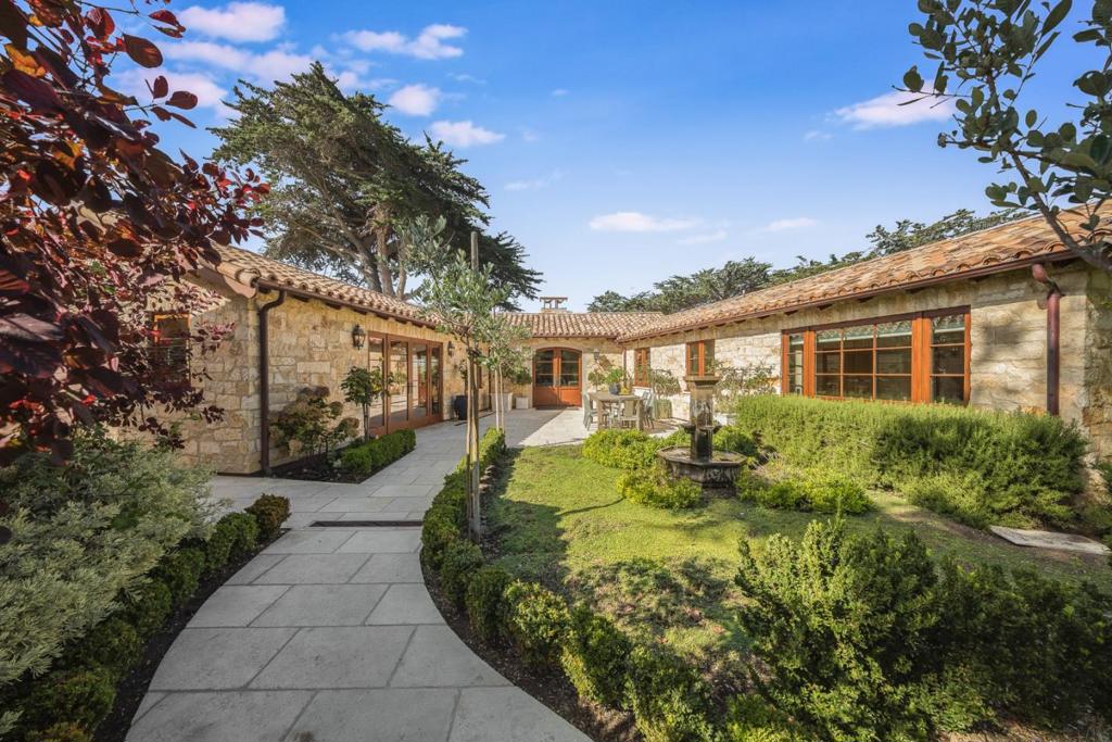 Masterfully, extensively, and exquisitely rebuilt home and ADU in 2017 in the Golden Rectangle of Carmel. 2 minute walk to the ocean and walking distance to downtown. Enjoy endless sunsets and the sound of the ocean in the private, peaceful, beautifully landscaped and gated property. Family and friends can gather for al fresco dining in the courtyard, sunsets on the back terrace or a cozy evening by the firepit. This exceptional French Mediterranean stone home features a European clay tile roof, mahogany windows, solid core oak doors, copper gutters, beamed ceilings, venetian plaster walls, authentic imported reclaimed Provence floor tiles, imported French oak floors, marble baths, bronze railings, solid walnut cabinetry, top of the line appliances, radiant heat, temperature control wine cellar, EV charger, Tesla Powerwall/power backup and a fully integrated security and Sonos sound system.