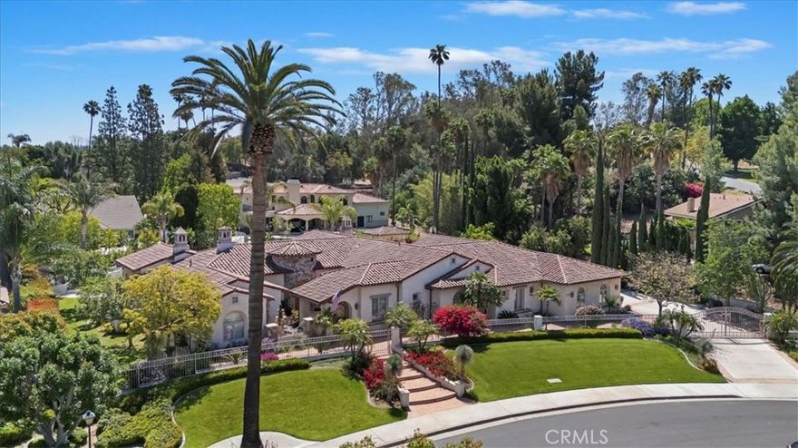 Timeless Mediterranean Masterpiece with Resort-Style Amenities. Welcome to this iconic custom-designed Mediterranean estate, offering 5,349 sq ft of luxurious living space complemented by a 1,999 sq ft finished attached garage with soaring 10' ceilings, extensive storage, workspace, and its own Sub-Zero refrigerator. Crafted with 2"x 8" structural exterior framed walls, this home boasts exceptional energy efficiency and a quiet, peaceful interior insulated from outside activity. A stunning array of windows floods the interior with natural light and frame picturesque views of the lush landscaping and tranquil water features.

Step outside to your own private resort—an expansive custom Bogner pool with waterfalls, fountains, wading areas, and a raised spa that seats 8+. Entertain effortlessly in the outdoor covered kitchen, complete with an eating bar, dance area, cozy evening seating, and a raised fire ring for year-round enjoyment. A private courtyard with a water feature adds another layer of serenity. Inside, the home features 4 spacious bedrooms, each with its own private en-suite bathroom, plus a dedicated study/office and guest powder room. The hotel-inspired primary suite is a private sanctuary, featuring a fireplace, surround sound, and an opulent en-suite bathroom with dual vanities, a large soaking tub, walk-in shower, and a massive custom closet complete with an island dresser cabinet. The grand formal living room, large enough to host a grand piano, flows seamlessly into the elegant formal dining area—ideal for entertaining in style. The chef’s kitchen is the heart of the home, featuring a large island workstation, breakfast counter, Subzero refrigerator, culinary style appliances include 2 dishwashers, commercial style Viking 48” stove with dual fuel ovens, double sinks with disposals. All overlooking the expansive family and entertainment room, which includes a custom wet bar, fireplace and charming daily dining area. Also, a convenient butler pantry between kitchen and formal dining area that features a walk-in pantry, Viking warming oven, a wine captain with variable temperature levels for wine storage and upper/lower custom cabinets. This home is truly a blend of timeless design, modern comfort, and unparalleled outdoor living.