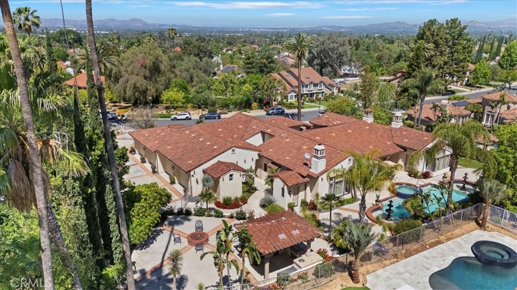 Timeless Mediterranean Masterpiece with Resort-Style Amenities. Welcome to this iconic custom-designed Mediterranean estate, offering 5,349 sq ft of luxurious living space complemented by a 1,999 sq ft finished attached garage with soaring 10' ceilings, extensive storage, workspace, and its own Sub-Zero refrigerator. Crafted with 2"x 8" structural exterior framed walls, this home boasts exceptional energy efficiency and a quiet, peaceful interior insulated from outside activity. A stunning array of windows floods the interior with natural light and frame picturesque views of the lush landscaping and tranquil water features.
Step outside to your own private resort—an expansive custom Bogner pool with waterfalls, fountains, wading areas, and a raised spa that seats 8+. Entertain effortlessly in the outdoor covered kitchen, complete with an eating bar, dance area, cozy evening seating, and a raised fire ring for year-round enjoyment. A private courtyard with a water feature adds another layer of serenity. Inside, the home features 4 spacious bedrooms, each with its own private en-suite bathroom, plus a dedicated study/office and guest powder room. The hotel-inspired primary suite is a private sanctuary, featuring a fireplace, surround sound, and an opulent en-suite bathroom with dual vanities, a large soaking tub, walk-in shower, and a massive custom closet complete with an island dresser cabinet. The grand formal living room, large enough to host a grand piano, flows seamlessly into the elegant formal dining area—ideal for entertaining in style. The chef’s kitchen is the heart of the home, featuring a large island workstation, breakfast counter, Subzero refrigerator, culinary style appliances include 2 dishwashers, commercial style Viking 48” stove with dual fuel ovens, double sinks with disposals. All overlooking the expansive family and entertainment room, which includes a custom wet bar, fireplace and charming daily dining area. Also, a convenient butler pantry between kitchen and formal dining area that features a walk-in pantry, Viking warming oven, a wine captain with variable temperature levels for wine storage and upper/lower custom cabinets. This home is truly a blend of timeless design, modern comfort, and unparalleled outdoor living.