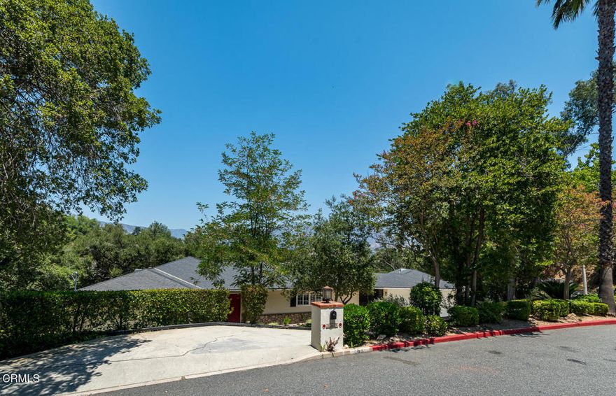 This sunny and light 1951-built traditional home sits on an absolutely beautiful 40,000+ sq ft Flintridge lot, providing the next owner a tremendous opportunity to expand on what is here and truly make it their own.  The living room, family room, and dining room all overlook and open out to the deck, covered patio, pool, and expansive wooded grounds. The kitchen features laundry area and walk-in pantry, and updates that include granite countertops and stainless-steel appliances.  Main level bedroom suite has updated full bath and walk-in closet. Spacious second bedrooms is steps away from updated 3/4 bath. Lower-level bedroom, updated 3/4 bathroom and office enjoy wooded views and seating area on private patio.  Large paned windows and French doors throughout provided beautiful views from almost every room in the house.  Two-car attached garage is just across covered breezeway from the kitchen.  Covered patio currently used for ping-pong could make a great studio or other space.  Swimming pool is easily accessed from the patio and deck as well as from lower private patio. Descanso Gardens-like setting with winding paths, mature landscaping, and treetop and mountain views. Incredible potential.  Bring your ideas and your contractor.
