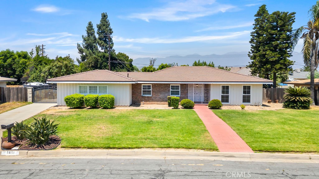 Welcome to this stunning home nestled in the city of Rialto. Tucked away in a peaceful neighborhood, this beautifully updated home awaits you. As you walk in, you are greeted by bright white walls and sleek, oak colored vinyl flooring throughout the living room, with a cozy fireplace serving as focal point. The living room flows seamlessly into the spacious dining area. There is a stylish peninsula that ties together the dining area to the tastefully remodeled kitchen, featuring crisp white cabinets, beautiful white quartz countertops, and modern appliances. The layout is perfect for hosting large gatherings. The rest of the home features updated bathrooms and sleek vinyl flooring throughout the rest of the home, providing a modern feel. The expansive backyard offers endless possibilities; add a sparkling pool, create the garden of your dreams, or design your ideal outdoor entertainment area. The property sits on over a 12,000 sqft lot. Close to shopping, schools, and very accessible to the 210 freeway. This home is the perfect turnkey home.