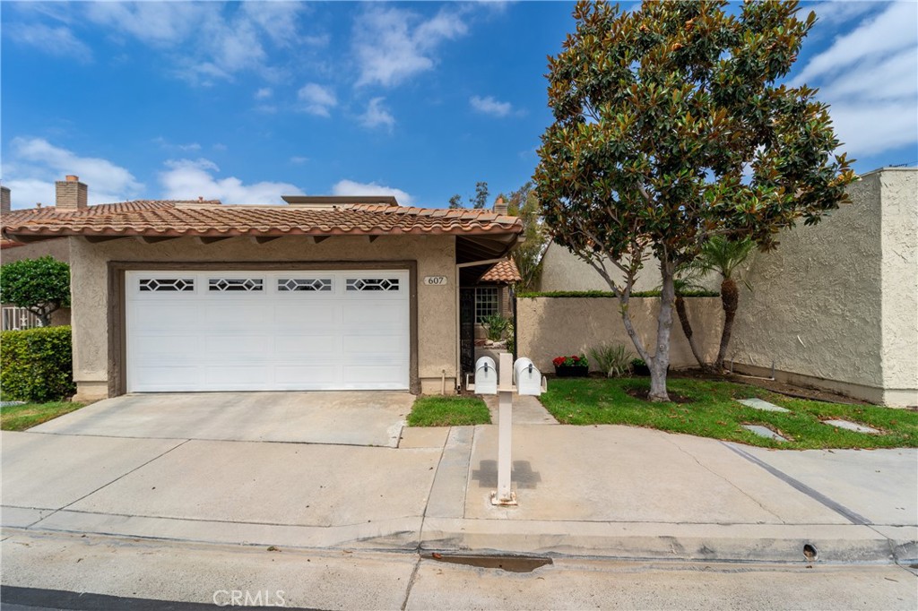 Beautiful Home in the highly desirable Granada Park gated community! Step through the double entry doors into a light-filled interior featuring cathedral ceiling and a cozy file place in the living room. With 4 spacious bedrooms and 3 bathrooms, including a convenient downstairs bedroom and bath, this layout is perfect for guests or multi-generational living. The home boasts multiple living areas, including a formal living room, dining room, family room and well appointed kitchen. Upstairs, the primary suite is with double doors, high ceiling, and plenty of space. The home is equipped with double pane windows for energy efficiency and a quiet, comfortable environment. A newer AC system installed approx. 5 years ago and replumbing done within the last 2 years, ensures year-round comfort and peace of mind. Enjoy beautifully enclosed yards-perfect for outdoor dining, entertaining or simply relaxing. Conveniently located walking distance to schools, near shopping and Fwy access, this home offers the perfect blend of comfort, style, and convenience. HOA covers roofing, exterior painting in every 5 years, basic internet/TV, front yard (detail to be confirmed with HOA). Don't miss out on this great opportunity!