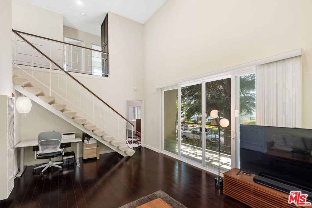 First showings Sunday, August 17th during the open house 2:00 PM to 5:00 PM. Bright west-facing townhouse in prime location with an almost panoramic treetop view. This beautifully remodeled dramatic 2-bedroom, 1 3/4 bath townhouse is located in a charming small courtyard building just 15 blocks from the ocean. A desirable front-facing corner unit, it enjoys windows on three sides with tranquil treetop views and an abundance of natural light. The home also has only one common wall! The spacious living room features dramatic tall ceilings, creating an open, airy feel. The updated kitchen offers a breakfast bar and opens seamlessly to the dining area & den area, perfect for both everyday living and entertaining. Both bathrooms have been tastefully renovated, and the home includes in-unit laundry for added convenience. Two generously sized bedrooms offer ample closet space, while the large private patio provides the perfect setting for outdoor relaxation. Additional features include two side-by-side parking spaces and a private, oversized storage room. Ideally located near public transportation, shops, restaurants, and a grocery store, this home is also in an excellent school district especially noted for its top-rated elementary school. A rare Westside gem combining comfort, style, and an unbeatable location!