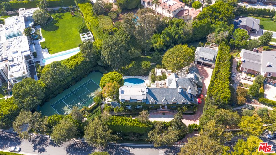 Located in the most prime section of Beverly Hills, a completely private and gated sanctuary. A stunning ivy covered traditional estate completely renovated in 2020 with incredible quality, style and taste. Steel doors and windows from all rooms open to stunning  gardens, outdoor living & dining rooms, lush rolling lawns, a resort like pool, outdoor kitchen/pizza oven, wonderful sitting areas, patios, fire pit, and a beautiful sunken tennis court. Enter into a sun drenched stunning 2-story foyer with beautiful wide-planked reclaimed wood floors, to a 50 ft living room with stone fireplace and white plaster walls, a large dining room with bar, an intimate paneled library/office, a full gourmet kitchen (and separate chefs kitchen)  which open to a family/media room, a professional screening room with bar, gym and separate guest house. An incredible master suite, large walk in closets and luxurious bath, and beautiful en suite family/guest rooms complete every amenity.  State-of-the-art security, lighting system, and A/V throughout. An absolutely spectacular property...Shown to prequalified buyers only.