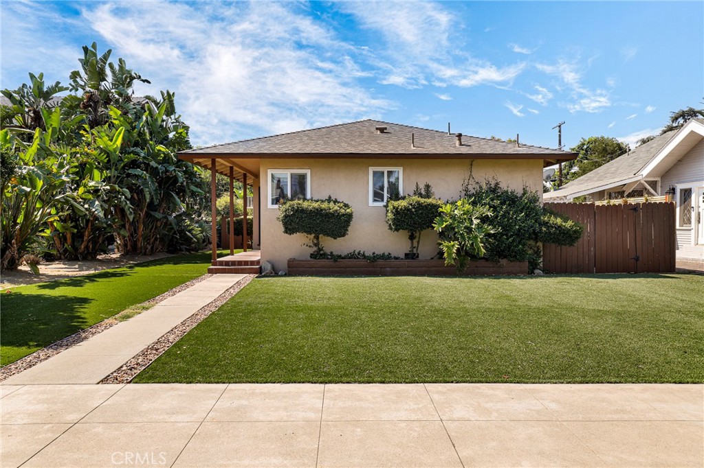 First time on the market in nearly 50 years, this property radiates warmth and pride of ownership. Welcome to this lovingly maintained home, nestled in a charming and historic neighborhood of Pomona. Step inside to find a spacious living room and a separate dining area, perfect for entertaining or relaxing. The kitchen features granite countertops, a cozy eat-in nook, and a conveniently located laundry area with a half bathroom. This home offers two comfortable bedrooms and a beautifully remodeled bathroom, complete with a classic claw-foot tub. The expansive backyard is a true highlight—featuring a covered patio area, two storage sheds, a basketball hoop, and new low-maintenance artificial turf throughout. The detached two-car garage, accessible via the alley, has been upgraded with insulation, carpeting, and a dropped ceiling—ideal for a workshop, gym, or bonus space. Recent upgrades and features include: Hardwood floors throughout; New roof and dual-pane windows (2 years ago); Whole-house fan; Insulated attic; Newer wood fencing; Replaced sewer line; Artificial turf in front and back yards for easy upkeep. Located just minutes from Ganesha Park, Cal Poly Pomona, and a vibrant local arts and dining scene, this home offers both comfort and convenience. Come see it for yourself—this is one you don’t want to miss