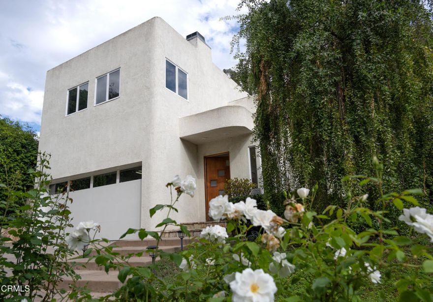 Secluded in the heart of Brentwood, this Art Deco Modern-style home was extensively remodeled & enlarged in the early 90's, features 4 or 5 bedrooms and 3.5 bathrooms. It offers spacious living areas filled with natural light, combining ample windows while maintaining privacy. As you enter, the home unfolds with high ceilings, prominent lines, a charming balcony, and a glimpse of the backyard. Each room is generously sized, with the living room showcasing lofty ceilings, plenty of windows, stylish design, and a dual-sided fireplace shared with the dining area. The dining space is enhanced by ambient lighting, a stunning chandelier, and a beautiful staircase with a balcony. From there, you flow into the kitchen and family room, which leads to the backyard. The large kitchen offers granite countertops, dual sinks, a spacious island, a breakfast bar, and a walk-in pantry. The cozy family room is an ideal spot to relax and take in the yard. The backyard boasts lush plants, ample space for entertaining, and with the addition of a lawn, it will complete the setting. Upstairs, an elegant stairway and landing overlook the lower level to three bedrooms and an office. All bedrooms are spacious and well-separated. The primary suite features high ceilings, a walk-in closet, a fireplace, and a large bathroom. Upstairs also features two more bedrooms and an office/5th bedroom, which includes a fireplace and a great view of the neighborhood. In addition, the home offers solar panels, a backup battery, and an electric car charger.