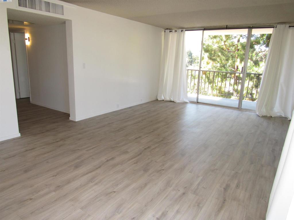 Light and bright condo on 4th floor of Parkway Towers. Wall of windows with balconies all across....livingroom and both bedrooms. Secured building with elevator. Common area coin operated laundry in building. LVP flooring throughout. Large Primary Bedroom with wall to wall closets on two sides. Updated kitchen. Gated parking, with 1 under ground parking space assigned. Community pool, clubhouse, fitness, tennis court. Centrally controlled HVAC with individual air controllers in condo. Central location, close to BART, park, shopping, Mission Blvd., 680 and 880. Views: Downtown