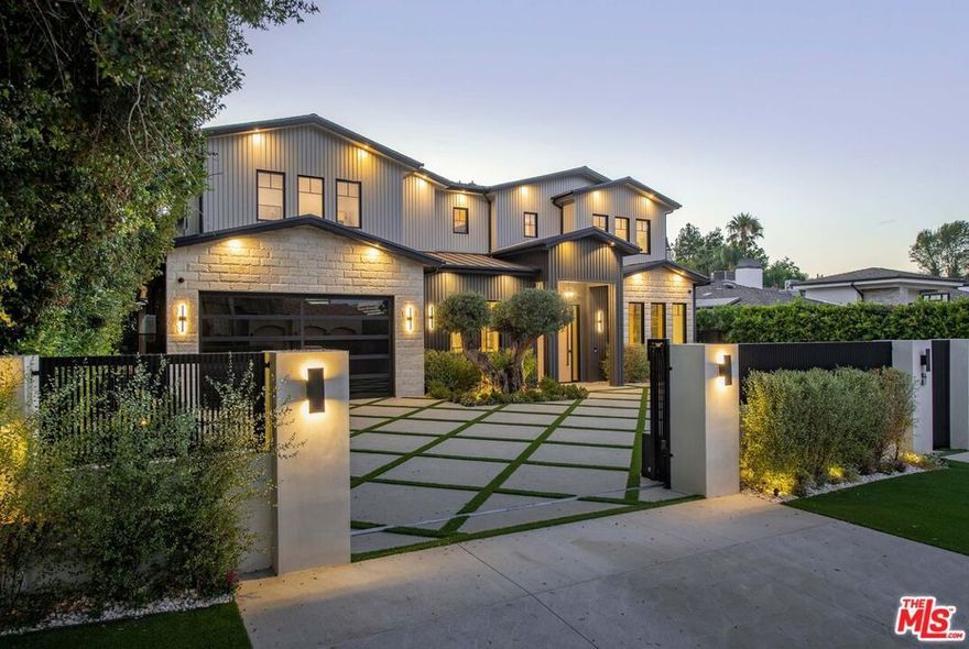 Welcome to this stunning new gated estate situated south of the Boulevard, in prime Encino. As you step through the grand entrance, you're greeted by an expansive open floor plan bathed in natural light. The formal living room, featuring a cozy fireplace and white oak accents, flows seamlessly into the elegant dining room. The gourmet chef's kitchen is a masterpiece, boasting two large islands, natural stone countertops, custom cabinetry, top-of-the-line Miele appliances, a walk-in pantry with an additional refrigerator, and an espresso machine. The kitchen opens to the spacious family room, which has its own fireplace, custom built-ins, and large sliding glass doors that create a harmonious indoor-outdoor living experience. The main level also offers an office with built-in cabinetry, a powder room, and a full ensuite bedroom with direct access to the backyard. Upstairs, the serene primary suite awaits, featuring a white oak pitched ceiling, a fireplace, two walk-in closets, and a private balcony overlooking the backyard. The spa-like primary bathroom offers dual vanities, a soaking tub, and an oversized shower. On this level, you'll also find a secondary living space with built-ins and a beverage fridge, three additional ensuite bedrooms, and a laundry room equipped with dual washers and dryers. The basement level is designed for ultimate entertainment and relaxation, with a generous living space, powder room, wet bar, walk-in wine room, theater, gym, ensuite bedroom, sauna, and steam shower. The home also features an elevator, Control4 smart system, and a three-car garage. Outside, the show-stopping backyard is an entertainer's dream, with a zero-edge pool and spa with a waterfall, a covered cabana patio, built-in barbecue, sports court, fire pit, and a detached recreation room with a full bath. Located in the highly acclaimed Lanai Road Elementary school district and just moments from the shops and dining on Ventura Blvd, this exceptional home is a must-see. Also available for lease at $47,000 / month.