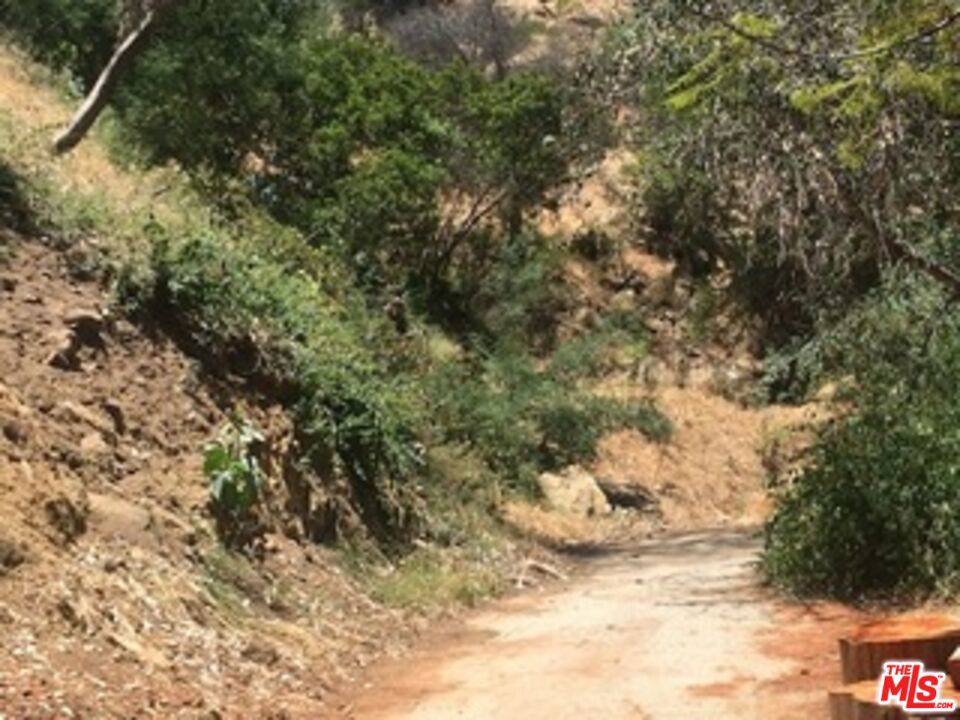 GREAT INVESTMENT! Remarkable and Inexpensive opportunity to own a parcel of lush land in the prestigious Bel Air area. Multi-Million dollar homes build in the area. This property is beyond the paved road. There is no car access. The exact location may need to be determined by survey or other means GPS 34.113358, -118.448510 Buy now and hold for the future. APN 4379-024-008 The Next Lot APN 4379-024-009 is also available for sale at the same price. ________ THE OWNER AND AGENT MAKE NO GUARANTEES, REPRESENTATIONS, OR WARRANTIES AS TO ACTUAL LOT SIZE AND/OR WHAT CAN BE BUILT CURRENTLY. BUYERS TO DO THEIR OWN INVESTIGATIONS USE CAUTION WHEN SHOWING AND/OR ATTEMPTING TO WALK ON THE LOT. RICED FOR A QUICK SALE, THE OWNER'S SACRIFICE IS YOUR GAIN...HURRY, THIS WILL NOT LAST