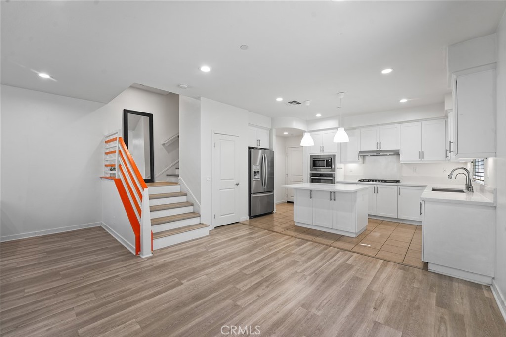 Welcome to this highly upgraded 4-bedroom, 3.5-bathroom townhome nestled in the heart of the sought-after Parasol Park community in Irvine’s Great Park. Spanning approximately 2,480 sqft across three levels, this end-unit offers modern style, comfort, and versatility. The main level boasts sleek laminate wood flooring, a spacious open-concept living and dining area, and a gourmet kitchen with a center island, quartz countertops, stainless steel appliances, pantry, and modern cabinetry. The second floor includes the primary suite with a walk-in closet and spa-inspired bath, plus two additional bedrooms (each with walk-in closets), shared full bath, and a laundry room. A private balcony off the living room provides the perfect spot to unwind. The third floor features a versatile loft, an additional bedroom, and an expansive covered deck, ideal for a home office, guest space, gym, or entertaining with sunset views. Additional features include a 2- car direct-access garage with a high-speed Tesla charger, energy-efficient windows, and abundant natural light throughout. Located just steps from resort-style pools, playgrounds, parks, trails, and top-rated Irvine schools like Cadence Park and Portola High. Conveniently close to Woodbury Town Center, Irvine Spectrum, and major freeways (I-5, 133, 241, and 261), this home truly has it all. Don’t miss your chance to lease this exceptional property! No pets allowed.