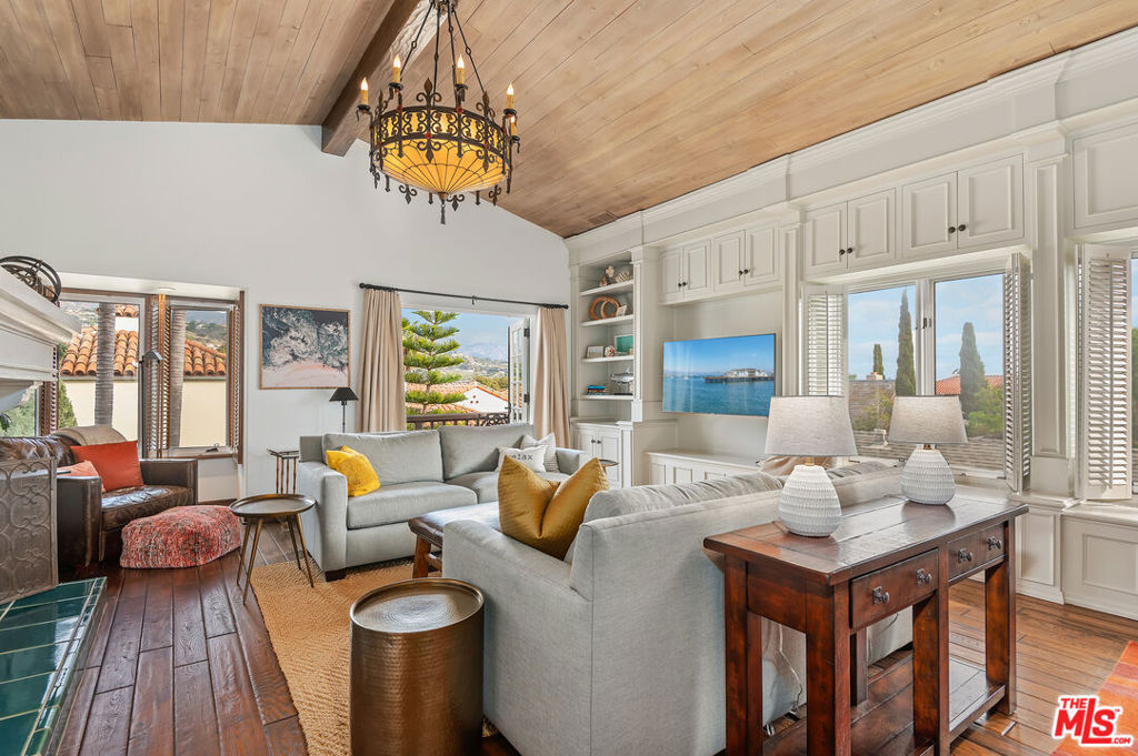 Classic Santa Barbara Charm Meets Modern Luxury - Welcome to this vibrant, beautifully remodeled condo nestled in the heart of downtown Santa Barbara. Offering stunning city and mountain views with glimpses of the ocean beyond iconic red-tiled rooftops, this home perfectly captures the essence of classic Santa Barbara living. Step inside to soaring vaulted ceilings with exposed wooden beams, a grand fireplace, and an open, airy layout filled with natural light. Elegant, high-end finishes and expertly crafted cabinetry create a seamless blend of sophistication and comfort. French doors and skylights throughout enhance the indoor/outdoor lifestyle, inviting the fresh coastal breeze into every room. The spacious primary suite is a serene retreat, featuring a spa-like bathroom, generous walk-in closet, and an adjacent office or den that opens to a private balcony ideal for morning coffee or evening relaxation. The guest bedroom enjoys peaceful views and is conveniently located near a beautifully appointed full bathroom just across the hall. Enjoy additional outdoor living with a view deck off the living room, perfect for entertaining or unwinding in the glow of the Santa Barbara sunset. Additional highlights include: One-car garage + covered carport. Dedicated laundry room. Wine refrigerators. Newer heating system & water heater. Impeccably maintained inside and out. This timeless residence offers a rare opportunity to live in a luxurious haven with unbeatable access to Santa Barbara's finest dining, shopping, and beaches.