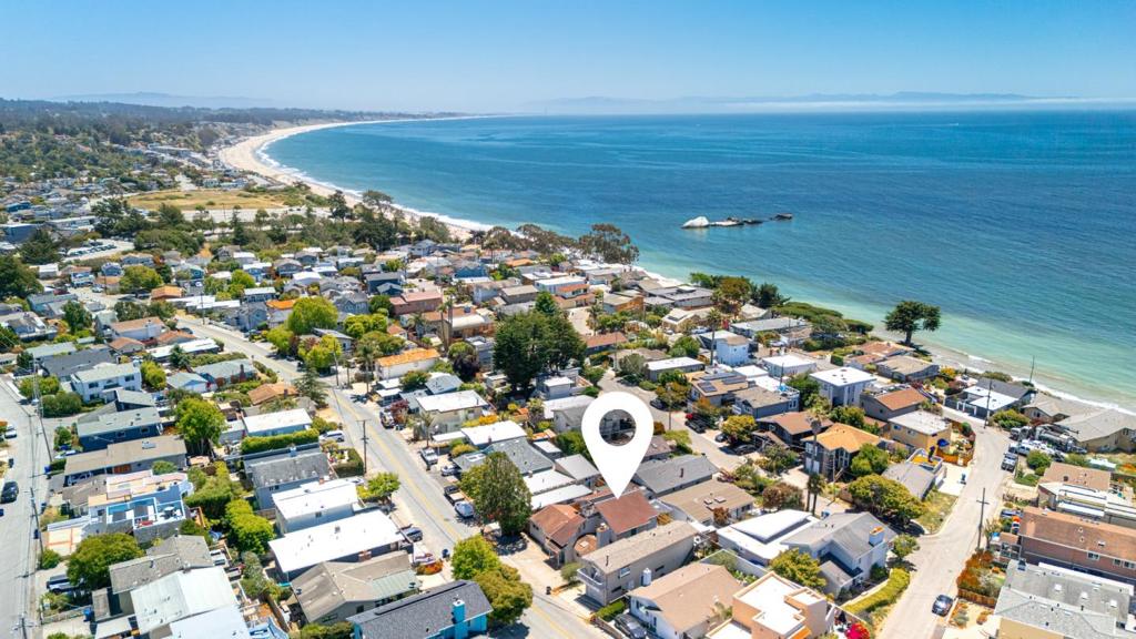 Welcome to your coastal retreat in the heart of Aptos! Situated on a large lot, this inviting beach house offers the perfect blend of comfort and seaside charm. The partial ocean view from the top floor offers the perfect backdrop for that beach style of living. Enjoy separation from downstairs with one bed and one bath upstairs, plus common living space and wet bar to take in the views. Downstairs features another bedroom and two common living spaces, where you can access the private back patio with lush tropical landscape. To top it all off, the location is as good as it gets. Located right around the corner from the Beachgate trail down to Seacliff beach where you can walk for miles. And with some of the best Mexican food just down the street at Manuel's and ice cream at the famous Marianne's, you simply cannot beat this location. Whether you're looking for a weekend getaway, multi-family living or a full-time residence, this property delivers in all the right ways.