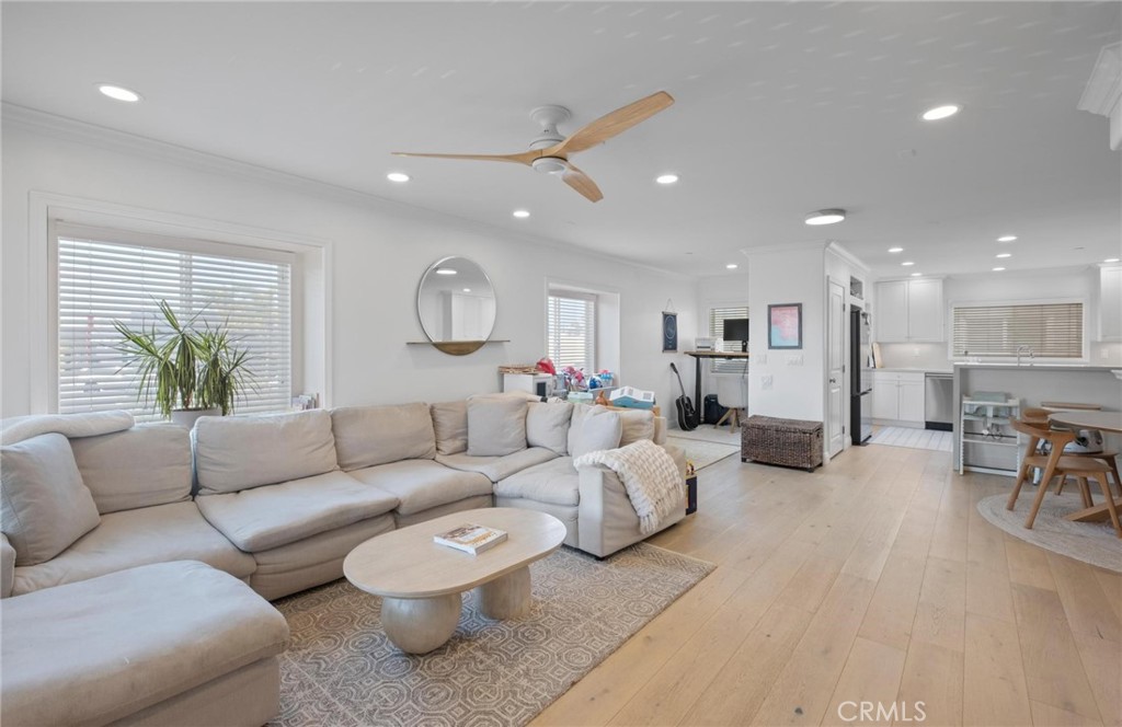 This fully renovated Cape Cod-style corner townhome offers 3 bedrooms and 2.5 bathrooms with a perfect blend of charm and modern upgrades. Located on a quiet cul-de-sac, just steps from award-winning schools, grocery stores, and top local restaurants. Built in 2005, the home features a bright and open floor plan with beautiful new wood floors, recessed lighting, a cozy fireplace, and a convenient powder room. An alcove off the living area provides the ideal space for a home office, reading nook, or play area. The completely updated kitchen boasts stainless steel appliances, including a wine refrigerator, a spacious pantry, and a private balcony perfect for grilling and outdoor dining. Upstairs, the primary suite includes a walk-in closet and a luxurious spa-inspired bathroom with a soaking tub. Two additional bedrooms share access to a private deck, allowing for extra outdoor space and cool breezes. Additional highlights include direct access to a three-car garage with side-by-side washer and dryer, built-in overhead storage, and the option to utilize the third parking space for recreational or fitness use. This turn-key home combines style, comfort, and convenience.