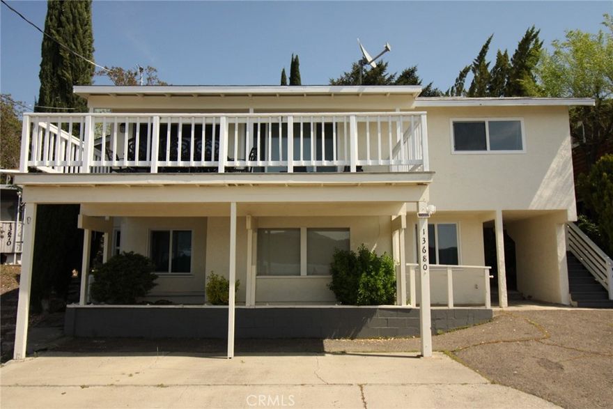 Welcome to Casa Blanca, an updated and private retreat on the water. This tastefully remodeled, four bedroom, three bath turn-key home has two separate levels, both with kitchens, and is an active Air B&B. This property is perfect for an investment, or anyone that wants a lakefront retreat that can also generate income. The top level features a private backyard, balcony overlooking the lake, and an open concept kitchen, dining, and living room. Complete with an updated kitchen with stainless steel appliances, dishwasher, and breakfast nook. The bottom floor is also completely updated and remodeled, with a private entrance from ground level. Lots of easy parking. Home comes fully furnished with expertly chosen pieces that compliment and accentuate the natural beauty and features of the home. This gorgeous property also includes a long dock directly across from the home on a dead end street. The home and dock are level with the street for easy access to the water for everyone in the family. Enjoy kayaking, boating, fishing, and swimming right from your own private yard and dock. This home is only minutes away from stores, amenities, and dining. Only 2 1/2 hours to the bay area, and 2 hours to Sacramento. This is a rare opportunity to own a completely turn-key home with easy access to the water, two separate units, and close to town yet still feeling private and off the main roads. Homes in this highly sought after area rarely hit the market!