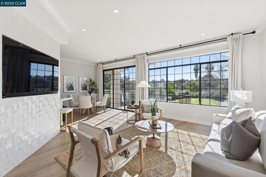 This beautifully renovated ground-floor condo, with over $200,000 in upgrades, offers a modern, luxurious living experience with stunning views of the lake and Canyon Lakes Golf Course. The open-concept layout connects the family room, dining area, and gourmet kitchen, featuring sleek quartz countertops, stainless steel appliances, and a spacious walk-in pantry. The primary suite is a private retreat with soaring ceilings, a custom walk-in closet, and a spa-like ensuite bath with designer finishes. Additional highlights include luxury plank flooring, recessed lighting, custom crown molding, and automatic Hunter Douglas shades. The condo is in the highly desirable Canyon Lakes community, offering resort-style amenities such as pools, tennis courts, walking trails, and social events. With a 2-car garage, enhanced landscaping, and easy access to top schools, dining, and shopping, this home offers a perfect blend of elegance, comfort, and modern convenience.