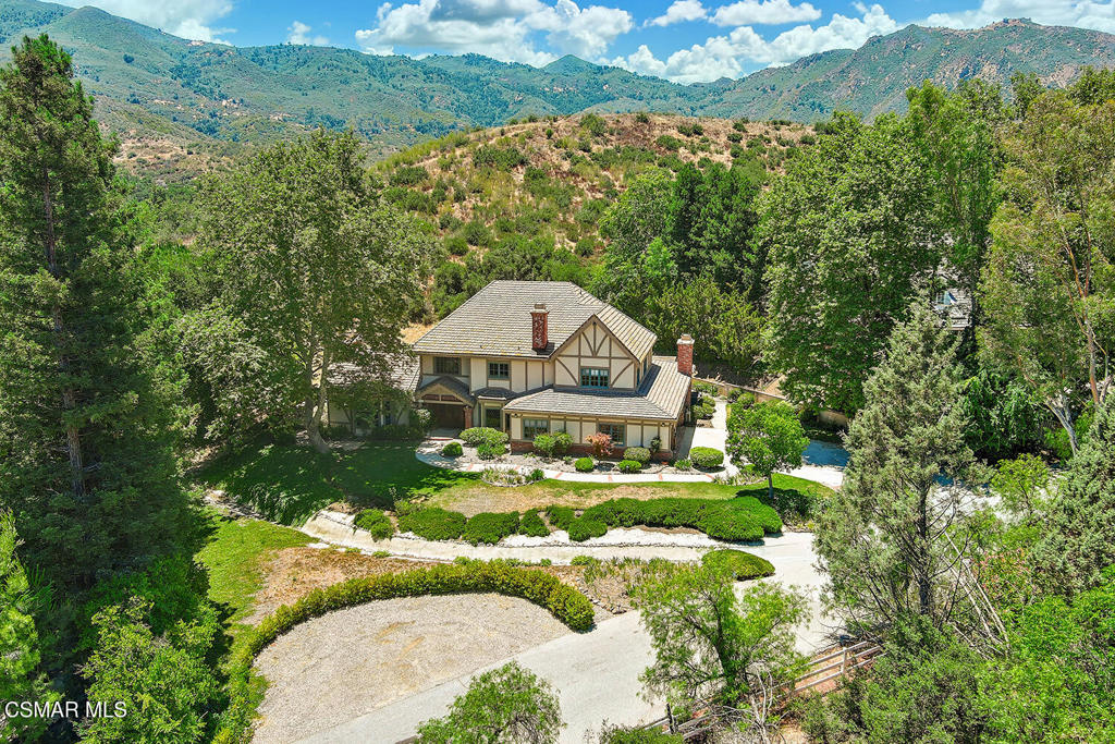 Nestled on an expansive lot in the scenic hills of Agoura, this exceptional estate offers the perfect blend of privacy, space, and sophistication. Ideal for those seeking serenity without sacrificing convenience, the property is minutes from upscale shopping, wineries, dining and top rated schools. Located in the Santa Monica mountains,Close proximity to the Santa Monica Mountains National Recreation Area, Zuma Beach, Point Dume, Paradise Cove, Cornell Wine Co. and much more. Located on a secluded private road shared with only 3 other neighbors, this one-of-a-kind property provides a rare sense of tranquility and exclusivity. Offering 5 bedrooms, 6 baths, and a spacious study, this 4,796 sq.ft. home on 1.36 acres has it all. Upon entering, you'll be captivated by the soaring high beamed wood ceilings. Spacious living areas, large picturesque windows and natural sunlight create a warm and sophisticated ambiance. The large gourmet kitchen and resort-style backyard are both perfect for entertaining. Step outside to the sparkling pool and spa with multiple lounge areas and incredible views of the open land, all of which are part of this magnificent property. The sprawling grounds offer opportunities for equestrian use, gardens, tennis and much, much more. The over- sized and air conditioned 3 car garage provides ample space for vehicles, storage and/or a workshop. Whether you're dreaming of a peaceful retreat, a luxury compound, or a creative haven surrounded by nature, this Agoura gem delivers the ultimate Southern California lifestyle in a true extraordinary setting.