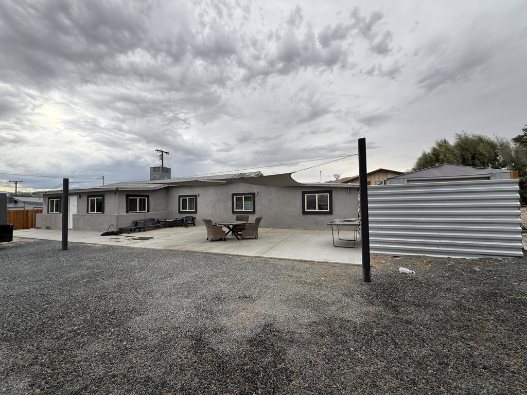 Welcome to your very own 1/2 acre Ranch! Beautiful property with sweeping mountain views and room to roam. This upgraded ranch home sits on a fully fenced 1/2 acre, offering privacy, style, and space to breathe. Walking as a 4 bed, 2 bath at approx. 1,400 sq ft, the home feels fresh and modern with new finishes throughout and a massive 12x30 shed for storage, projects, or play. Enjoy crisp, clean water from every tap with the premium Nuvia Pro Alkaline Water System included. Recent 2023 upgrades bring peace of mind and comfort--new roof, stucco, dual pane windows, a powerful 5-ton A/C heat pump, quartz countertops, tiled baths, and sleek LED lighting inside and out. Each bedroom shines with new mirrored closet doors, while the property's galvanized long-span fencing wraps the entire ranch in both security and style. This property is ready to enjoy from day one. Offered AS-IS, it's the perfect mix of classic desert ranch character and today's modern upgrades.