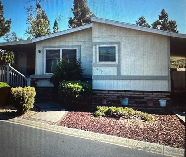 Welcome to this original-condition mobile home with no space rent and own you own land nestled in the heart of Carlsbad. This 2-bedroom, 2-bathroom home offers a spacious open floor plan and a touch of vintage charm throughout. Features include a generous front porch perfect for relaxing, wood plank flooring, classic flowered wallpaper, and a cozy brick fireplace. With great bones and plenty of character, this home is full of potential for the right buyer to make it their own.