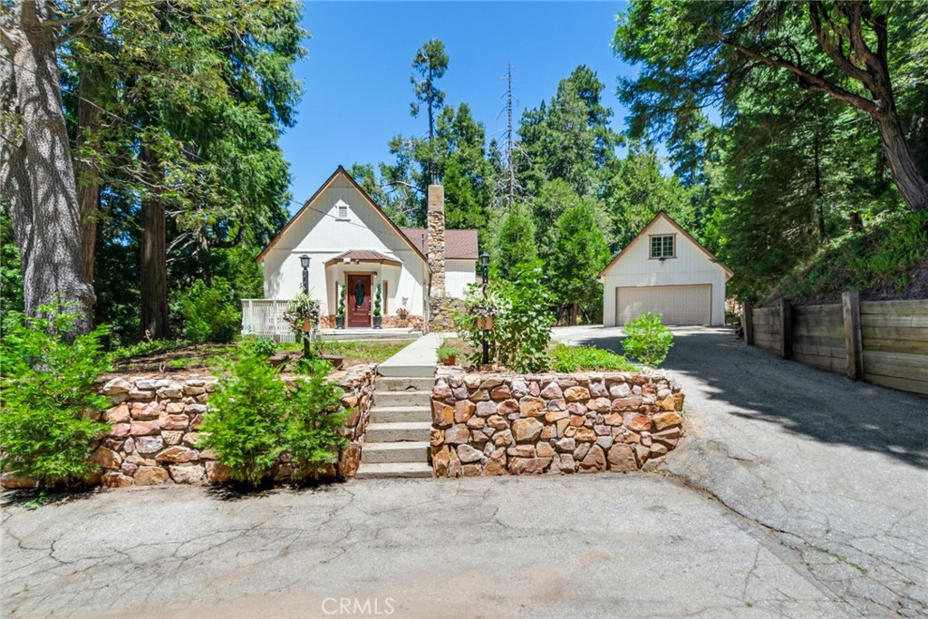 Discover the charm of this exquisite cottage, nestled in the highly sought-after Crest Estates, just a stone's throw from the picturesque Lake Arrowhead Village and the shimmering lake. Set on over an acre of lush, tree-filled land, this property provides a serene sanctuary with the utmost privacy. The tree views from the windows is fantastic and like living in the trees and you have an actual yard for enjoying the scenery.
The cottage has been lovingly remodeled to blend modern comforts with rustic elegance, featuring a spacious main house that boasts 3 bedrooms and 2.5 beautifully appointed bathrooms. Uncommon for the area, this property offers generous parking options, ensuring convenience for you and your guests. There is also addition parking located towards the bottom of the driveway.
Adding to its allure is a detached 2-car garage, complete with an enchanting studio above. This charming space includes a delightful kitchenette that includes kitchen sink, 2 burner convection stovetop and a small dishwasher, making it perfect for guests or as a creative retreat. Don’t miss the opportunity to call this captivating cottage your home!