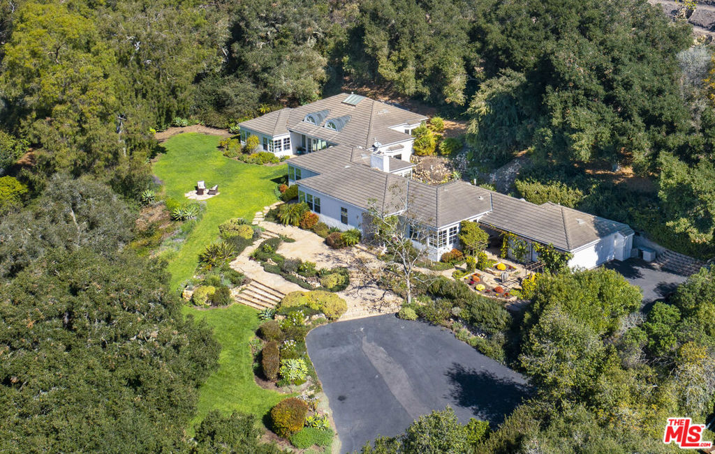 Situated on a coveted street in the sought after Hope Ranch community is 4580 Via Huerto; where traditional style meets cape cod to make up this sun filled dream home. Lush landscape and emerald green lawns surround the property with vistas and spectacular views of the sunset over the Santa Ynez mountains and beyond. With over 1.5 acres of land, the serene privacy of this home is instantly felt as soon as you step foot on the property. Be instantly greeted by the heart of the home; with a formal entry that leads to a naturally lit, south facing dining room just off the large entertainer's kitchen. The kitchen is equipped with stainless steel appliances, double ovens, a large granite island with built-in microwave, wood uppers and lowers, plenty of storage space, and a sink with a beautifulview out to your courtyard.Just down the hall is a formal living room with tasteful details and incredible light, a large fireplace with stone inlay creating a perfect place to enjoy a morning cup of coffee or an evening cocktail when entertaining. Down the beautiful hallway that opens to the back patio is a large sitting room with large picturesque windows, and french doors to the front gardens and views to the west. Also downstairs is a guest bedroom with a full bath conveniently located nearby, a lovely paneled office, laundry room, and the large master suite with grand windows taking advantage of views of the majestic mature trees just outside where one can enjoy our beautiful weather by a quaint firepit and seating area. The first floor master suite also enjoys two walk-in closets, and a large bathroom with a double vanity, shower and soaking tub.The home has a magical flow mostly being all single level, with just a short flight of stairs which take you to two guest bedrooms each with their own en-suite bathrooms, as well as a bonus room perfect for a music room, art studio, nursery, or whatever your heart dreams up!With new interior paint, new carpeting, and new lighting; the home's charm and grace is simply remarkable. Last but not least is a two car garage, and an outdoor shower and storage area conveniently located after days enjoyed at the private beach close by. Find pleasure in all the amenities the Hope Ranch community offers including private beach access, tennis courts, horse riding and walking trails that span for miles.