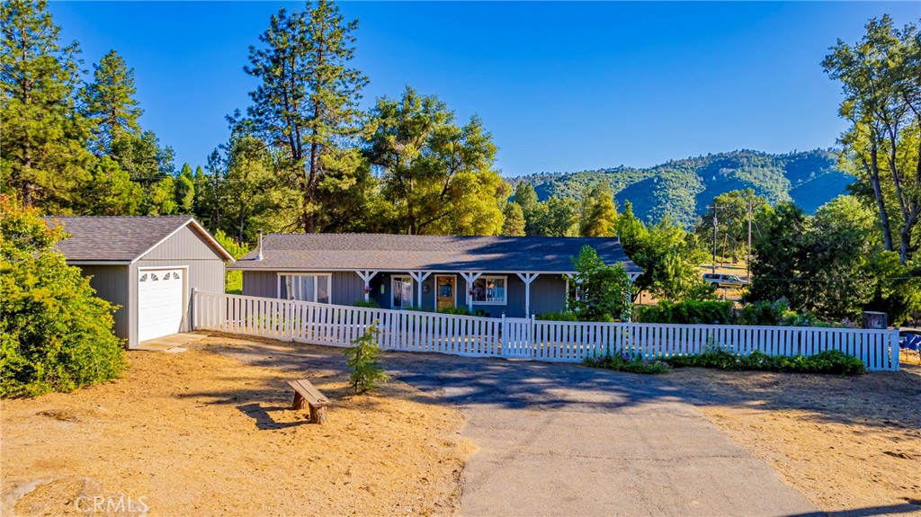 Known as The Farmhaus, this charming ranch-style home is sure to capture your heart. Not only is it ideally located close to Oakhurst, Bass Lake, Chukchansi Casino and Yosemite National Park, but it also backs up to a quiet neighborhood perfect for your daily walk! The home’s old time charm has been lovingly updated for modern comfort. New LPV flooring, dual pane windows, and composition roof. There’s a newer mini split for cooling and heating as well as an HVAC system and cozy pellet stove. Relax on the front or back porch, or enjoy the acre of useable land with peach trees, apple trees, and almond tree and grape vines! This is a one of a kind property that is sure to capture your heart!