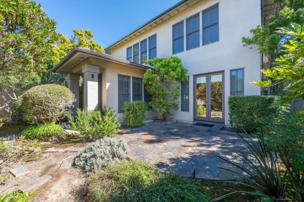 Overlooking the iconic 12th hole of Spanish Bay Golf Links, this luxurious end-unit condo offers an exceptional 4,032± sq. ft. of refined living. The versatile layout features 4 spacious bedrooms and 4.5 baths, including an expansive primary suite and three additional ensuite guest rooms, perfect for both privacy and comfort. Elegant touches abound with a library/den, separate office, formal dining room, and a gourmet kitchen designed to inspire showcasing custom granite and marble finishes. The inviting formal entry welcomes you into an elegant living space with timeless hardwood and slate flooring. This luxurious end-unit condo features private courtyards, while the backyard offers a serene, secluded setting overlooking the Spanish Bay Golf Links. With a two-car garage and effortless access to the upscale amenities of The Inn at Spanish Bay, this residence embodies the best of resort living within the exclusive, tranquil community of Pebble Beach.