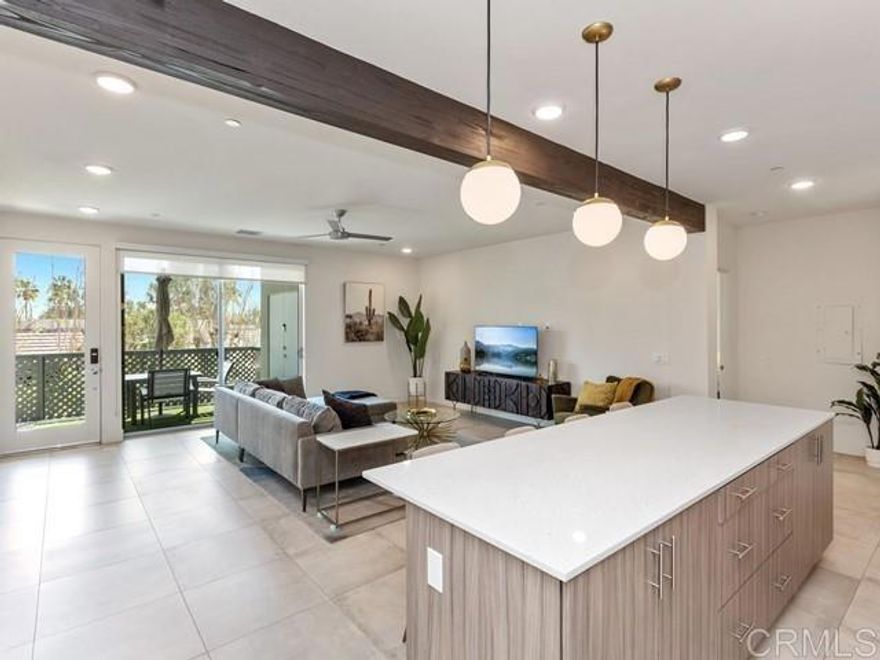 Modern, stylish, and priced to move! This bright and beautifully appointed upper-level condo with covered balcony and storage offers incredible value in uptown Design District. Furnished with sleek West Elm pieces, this newer construction home features an open floor plan with soaring 9' ceilings, floor-to-ceiling windows, and a spacious kitchen equipped with quartz counters, designer pendant lights, stainless steel appliances, and an island for easy entertaining. The eastern exposure brings in soft morning light through lush greenery, creating a peaceful and private setting. You'll love the spa-like bathrooms, washer/dryer, window treatments, and a private patio with storage. Residents enjoy resort-style amenities including a 60’ pool and spa, fire features, outdoor lounges, BBQs, gated dog park, and breathtaking mountain views. Covered carport parking, guest spaces, and community EV charging make life here easy. Located near Desert Regional Medical Center, Uptown Design District, and a short stroll to downtown Palm Springs — this is a smart move for those looking to live the Palm Springs lifestyle without overpaying.