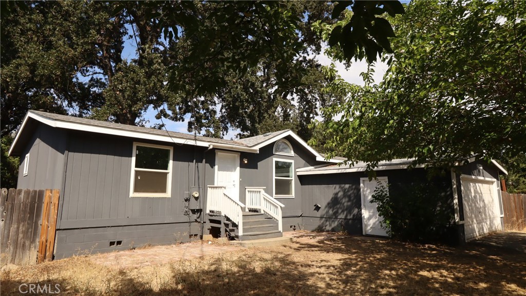 Charming Upgrades, Outdoor Living, Ideal Location! This charming three bedroom, two bath home offers 1,200 square feet of thoughtfully designed living space with high ceilings, abundant natural light, and a well-considered floor plan that places the primary suite on one side and additional bedrooms on the other. Recent upgrades include new flooring, fresh exterior paint including the porch, new front steps, select new windows, a newer HVAC system, extra insulation for year-round comfort and a durable concrete perimeter foundation.. The back door opens onto a beautiful 580 sq. ft. covered deck, perfect for outdoor dining, entertaining, or simply relaxing while overlooking the level, fully fenced double corner lot shaded by mature oaks. A gardener’s dream, the expansive yard provides sunny areas for planting as well as plenty of room for play or projects. Just minutes from Clear Lake’s public boat launches, fishing, swimming, and water sports—as well as local shopping, dining, and nearby wine country—this property offers the best of Lake County living. Whether you’re a retiree seeking a peaceful setting, a first-time buyer looking for an affordable move-in ready home, or an investor searching for a versatile rental property near recreation, this home blends comfort, convenience, and outdoor enjoyment in one inviting package