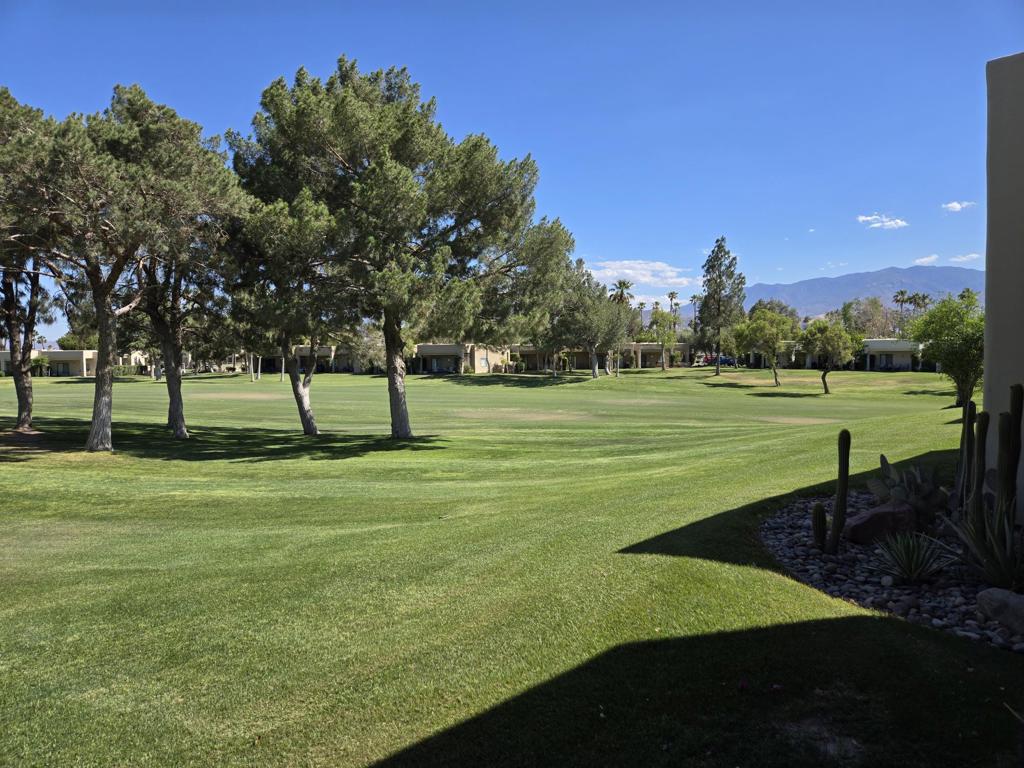Stunning Light-Filled End-Unit Home with Panoramic Mountain Views in Gated Resort Community. Welcome to your dream retreat in this beautifully updated END UNIT! 1-bedroom, 2-bathroom condo, nestled in a gated resort-style country club community. This light-filled home offers a rare combination of modern upgrades, energy efficiency, and breathtaking panoramic views of the surrounding mountains from both the front and back patios, perfect for peaceful mornings or unwinding at sunset. This home is perfectly positioned to maximize morning light and afternoon shade on those sunny desert days. Step into a spacious open-concept living room featuring rich wood grain flooring, newly updated recessed lighting, light filtering curtains for energy conservation and added comfort, and fresh custom paint throughout; creating an airy, sophisticated atmosphere. The master suite is a private sanctuary, boasting generous space and brand-new light-filtering curtains matching the living room. Enjoy cooking and entertaining with ease in the open-bar kitchen, while guests will be impressed by the two fully renovated bathrooms showcasing modern finishes and elegant touches throughout. Experience year-round comfort with a high-end, soft start HVAC system conveniently controlled by an integrated EcoBee system with WiFi and Alexa options, and a brand-new top quality water heater, both designed for whisper-quiet performance and maximum energy efficiency. Additional features include: Detached one-car garage Custom painted interior Sold unfurnished for you to personalize Easy gate access for convenience and securityLand Lease extended to 2069. Monthly ground rent is $149.68. HOA dues include: 2 DVR or HD cable boxes and service, high-speed internet, grounds maintained to your door by HOA maintenance crews, outside pest control when requested, and outside water. Gated community with 24-hour guarded gate access and regular patrols for added safety and security, health and fitness center membership, tennis, bocce ball, and pickleball courts. Discounts and preferred tee-times for owners at the Desert Princess 27-hole PGA Championship golf course, no initiation fees, rated among the best in the valley by Golf Digest. Don't miss the opportunity to live in luxury with every modern comfort at your fingertips. Schedule your private showing today and see why this exceptional condo is the perfect place to call home.