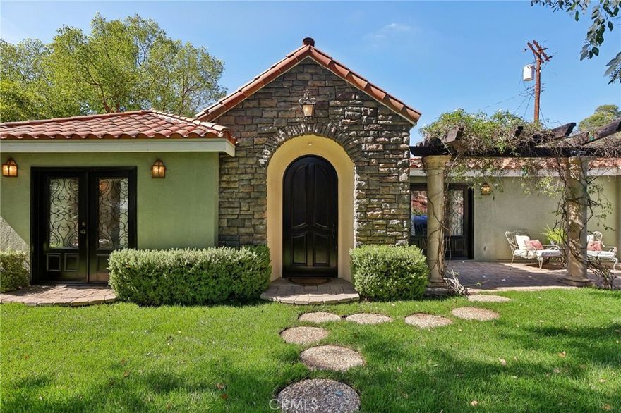Exquisite Single-Story Home in Prime Woodland Hills – South of the Boulevard!  Welcome to a rare offering in one of Woodland Hills’ most coveted neighborhoods—an impeccably appointed, move-in-ready single-story residence boasting timeless elegance, luxurious finishes, and over 2,550 SQFT of thoughtfully designed living space.  This sophisticated 3-bedroom + office, 2-bathroom home effortlessly blends classic charm.  Step through the formal foyer into a stunning entertainer’s living room, highlighted by soaring wood-beamed ceilings, a statement gas fireplace, and an open, inviting layout. The gourmet kitchen adorned with elegant French-style cabinetry, a premium 6-burner Viking gas range, built-in refrigerator, and a cozy breakfast nook framed by an expansive picture window showcasing tranquil views of the lush, manicured backyard.  Custom French doors seamlessly connect indoor and outdoor living, opening to a breathtaking private oasis designed for both relaxation and grand entertaining. The resort-style backyard features a sparkling Pebble Tec pool, a covered patio with a charming outdoor fireplace, vibrant landscaping, multiple mature fruit trees, and an ambiance of total seclusion.  Perfectly positioned just minutes from the high-end shops and restaurants of The Village at Topanga, Westfield Mall, and a short drive to the iconic Calabasas Commons, this extraordinary residence offers luxury, location, and lifestyle at an exceptional value.  A true gem and one of the best-priced homes in this prestigious enclave.