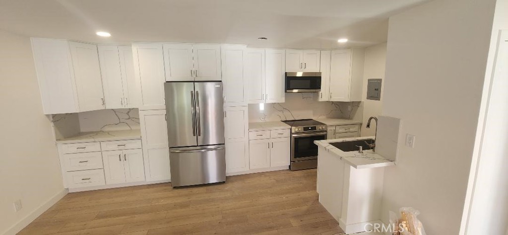 Model like South Coast Metro Area Remodeled Two Bedrooms, Two Baths Condo in the Woodside Village Community . Features include a chef's dream kitchen with a open design with new white shaker cabinets with soft close features and pull outs / new stainless Frigidaire appliances ( slide in electric range stove oven / dishwasher / microwave ) / recessed lighting / stunning white quartz counters and backsplashes up to upper cabinets , New Window Coverings , Master Bedroom has new mirrored wardrobe closet doors and a private Bath with a new Walk in Tiled Shower with bench and a frameless shower door , New Central Payne Air Condition and Heat , New Double Pane Vinyl Windows & Slider , Smooth Ceilings , New Hardwood Style Vinyl Plank Floors and New Berber Style Carpeting , New Raised Panel Solid Doors & Closet Doors , One carport & one unassigned parking space , Upper End Location , New Faucets / Door Knobs / Towel rods / New Mix it Valves / New Angle Stops / New high Baseboards / New Garbage Disposal / New Stainless Sink / New Bath Lighting / Freshly Painted in Two Tone Colors / Balcony , new Electric Breaker Box , hoa dues include gas / water / trash / sewer . Gated Woodside Village is close to South Coast Plaza , fine dining , movies , & freeways .