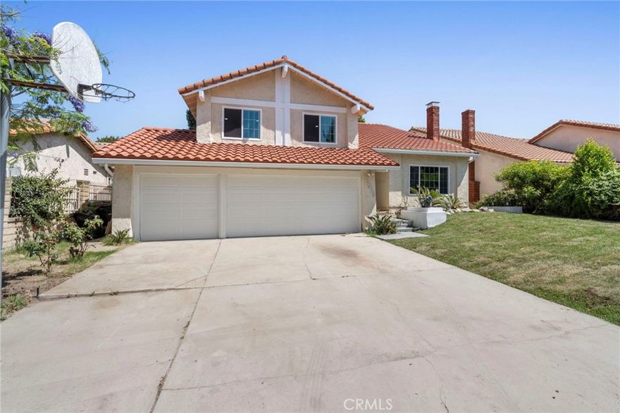 Discover this beautifully remodeled tri-level home in sought-after Granada Hills, offering the perfect blend of modern elegance and family comfort. Boasting 5 spacious bedrooms and 3 updated bathrooms across 2,769 square feet, this residence sits on an expansive nearly 7,500 square foot lot. The inviting living room welcomes you with soaring vaulted ceilings, wood-style flooring throughout, and a charming wood-burning fireplace, seamlessly flowing to a formal dining area highlighted by a custom chandelier—ideal for hosting memorable gatherings. The contemporary kitchen is a chef’s dream, featuring crisp white cabinetry, quartz-style countertops, stainless steel appliances, and a sunlit breakfast nook overlooking the backyard. Upstairs, the luxurious primary suite showcases a remodeled en-suite bath with high-end finishes, modern fixtures, and a walk-in closet, while additional bedrooms and a remodeled hall bath offer flexibility for family, guests, or a home office. Downstairs, an extra-large bedroom with an adjacent full bath is perfectly suited for guests or multi-generational living. Step outside to a private backyard oasis with a spacious tiled patio, wood cover, mature fruit trees, and ample room for entertaining, gardening, or relaxation. Completing this ideal package is a three-car garage with abundant storage, plus easy access to shopping, dining, and transportation. Experience modern comfort, space, and style—make this move-in ready home yours today!