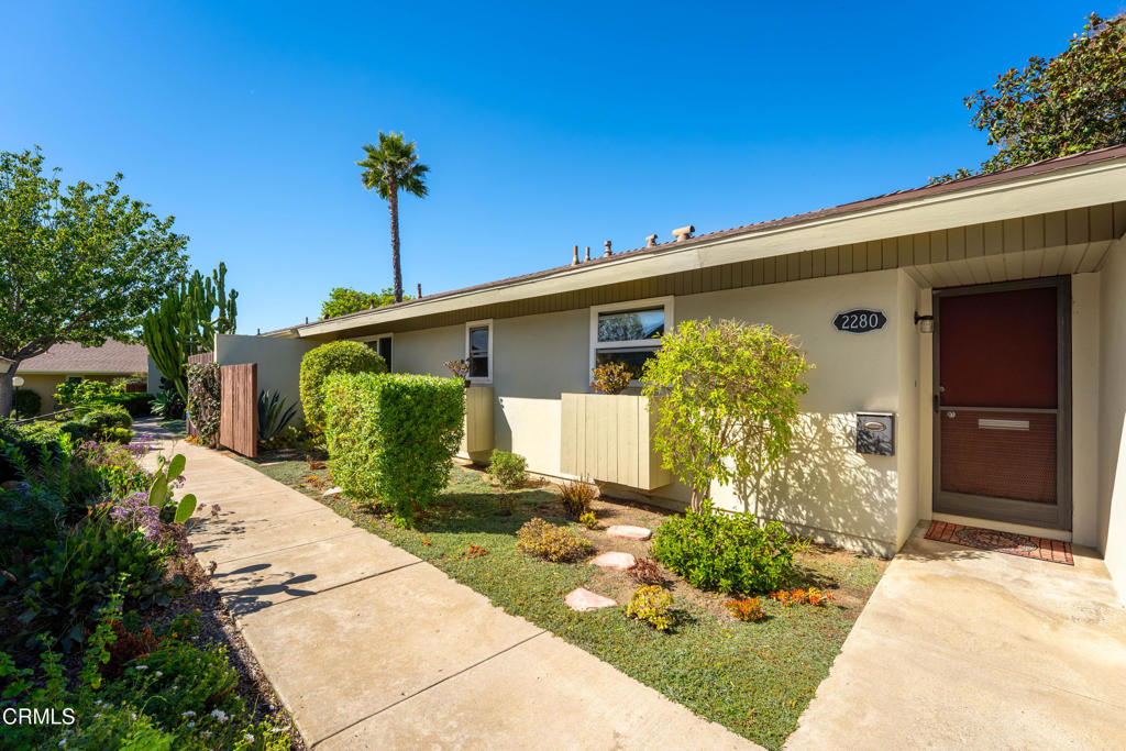 Welcome to Las Posas Gardens. A peaceful and well-kept community in the heart of Camarillo. Step through your entrance into an inviting single-story, two-bedroom, two-bath home with an open, light-filled layout. The spacious living and dining area features a cozy fireplace and sliding doors leading to a patio surrounded by greenery, perfect for relaxing or entertaining. Enjoy lush green views out every window, gentle hill views, and charming garden spaces in both the front and back.The kitchen is conveniently located just off the living space, featuring a warm, welcoming design that makes everyday living easy. The primary suite is a serene retreat, showcasing hardwood floors, two large closets, a newly renovated ensuite bath, and direct access to a secluded patio, ideal for quiet mornings or unwinding at the end of the day.Additional highlights include neutral finishes throughout, beautiful natural light, new vertical blinds, washing machine and hot water heater. Two assigned carport spaces with storage.Residents of Las Posas Gardens enjoy resort-style amenities including two sparkling pools, clubhouse, community laundry rooms, RV parking, and pet-friendly. Ideally situated near shopping, dining, and parks, this home combines comfort, convenience, and community charm.
