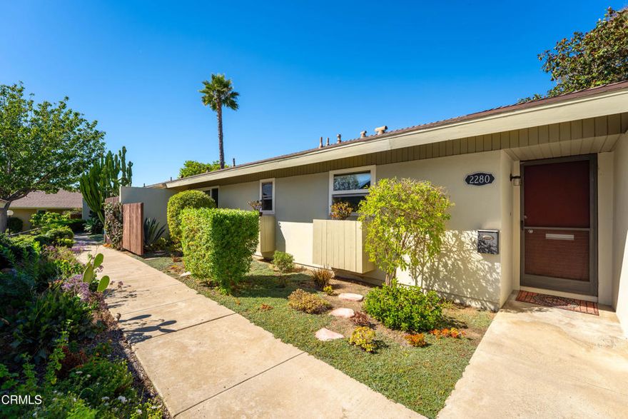 Welcome to Las Posas Gardens. A peaceful and well-kept community in the heart of Camarillo. Step through your entrance into an inviting single-story, two-bedroom, two-bath home with an open, light-filled layout. The spacious living and dining area features a cozy fireplace and sliding doors leading to a patio surrounded by greenery, perfect for relaxing or entertaining. Enjoy lush green views out every window, gentle hill views, and charming garden spaces in both the front and back.The kitchen is conveniently located just off the living space, featuring a warm, welcoming design that makes everyday living easy. The primary suite is a serene retreat, showcasing hardwood floors, two large closets, a newly renovated ensuite bath, and direct access to a secluded patio, ideal for quiet mornings or unwinding at the end of the day.Additional highlights include neutral finishes throughout, beautiful natural light, new vertical blinds, washing machine and hot water heater. Two assigned carport spaces with storage.Residents of Las Posas Gardens enjoy resort-style amenities including two sparkling pools, clubhouse, community laundry rooms, RV parking, and pet-friendly. Ideally situated near shopping, dining, and parks, this home combines comfort, convenience, and community charm.