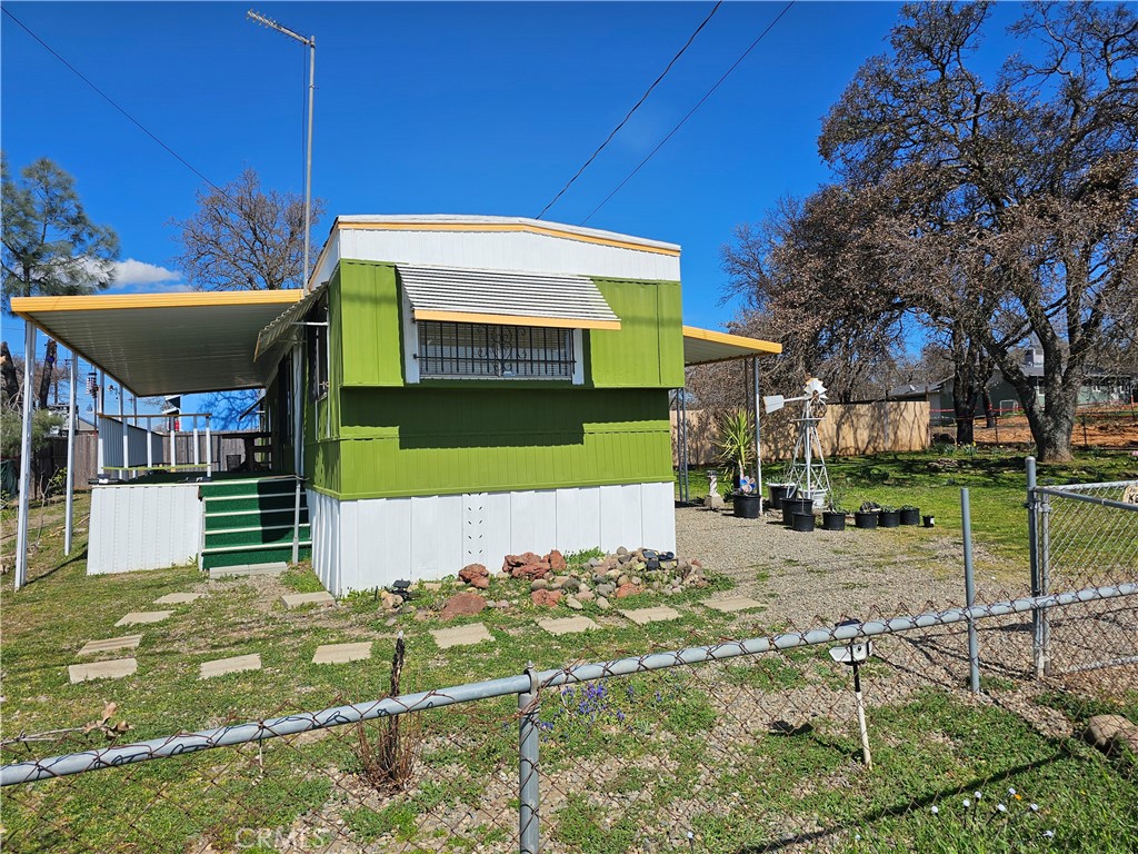 Tucked beneath the shade of a majestic oak tree, this well-maintained mobile home sits on a spacious double lot, offering room to breathe and enjoy the outdoors. The large covered porch is perfect for relaxing or entertaining, rain or shine. Inside, the home features new lighting, a new water heater, and a new refrigerator, making it move-in ready with peace of mind. Whether you're looking for a full-time residence or a weekend retreat, you'll love the convenience of being close to shopping, dining, and other local amenities. This charming property blends comfort, value, and location—don’t miss your chance to make it yours!