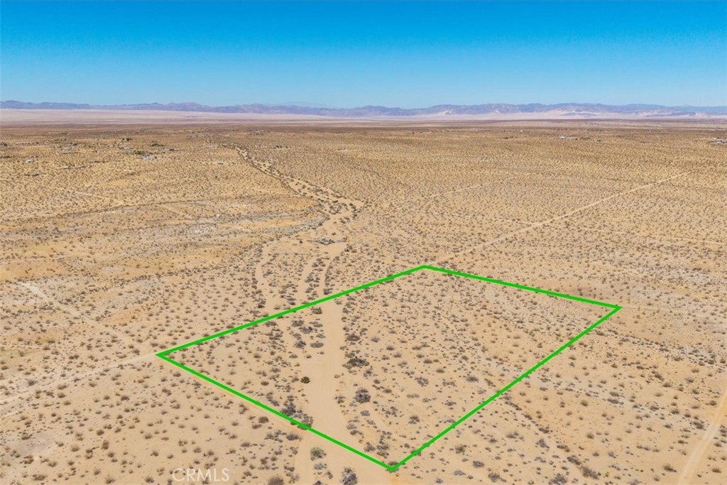 Expansive land in North Joshua Tree offering sweeping views in every direction, where open desert and dramatic skies define the setting. The property provides a choice of building sites, including a gentle rise that captures wide horizons stretching toward Pioneertown, Big Bear, and the Amboy hills. Just a short drive brings you to the Village of Joshua Tree with its art galleries, cafes, and music venues, or head into Joshua Tree National Park for world-class hiking, climbing, and stargazing. The site’s quiet, open space lends itself to a retreat, vacation escape, or future desert home. Solar and a private well may be the best utility options, though buyers should verify. This is a place where brilliant sunrises, star-filled nights, and the beauty of native desert landscape set the stage for your vision.