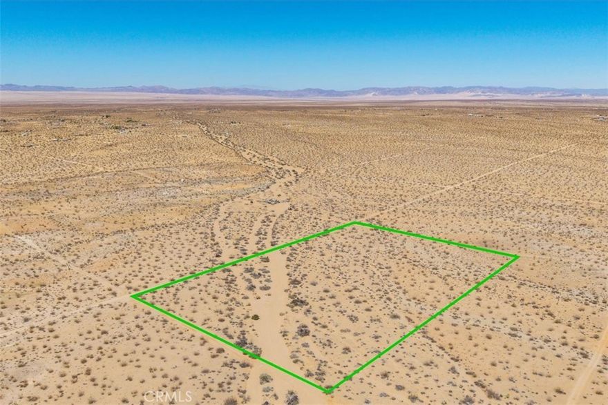 Expansive land in North Joshua Tree offering sweeping views in every direction, where open desert and dramatic skies define the setting. The property provides a choice of building sites, including a gentle rise that captures wide horizons stretching toward Pioneertown, Big Bear, and the Amboy hills. Just a short drive brings you to the Village of Joshua Tree with its art galleries, cafes, and music venues, or head into Joshua Tree National Park for world-class hiking, climbing, and stargazing. The site’s quiet, open space lends itself to a retreat, vacation escape, or future desert home. Solar and a private well may be the best utility options, though buyers should verify. This is a place where brilliant sunrises, star-filled nights, and the beauty of native desert landscape set the stage for your vision.