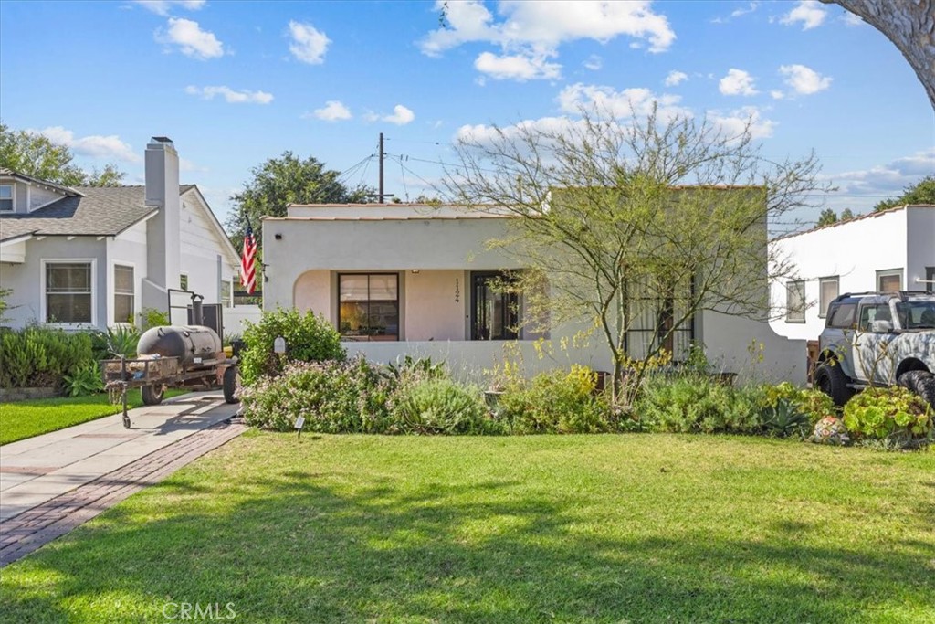 Must see this California Spanish Bungalow on Fullerton’s “Storybook Streets”! This 1925 gem blends vintage charm with modern updates: new smooth stucco, clay tile parapet roofline, 40-year torch-down roof, and original wood Mullion picture windows. Inside, refinished hardwood floors, a permitted primary suite, and a Batchelder-style fireplace create timeless elegance. The kitchen boasts Saltillo tile, honed marble counters, custom shaker cabinetry, and vintage-inspired hardware. Bathroom features a clawfoot tub, subway tile, and period accents. Upgraded with 200-amp electrical, copper/PEX plumbing and tankless water heater. French doors open to a secret garden with entertainment space. Just blocks from downtown, shops, colleges, and museums.