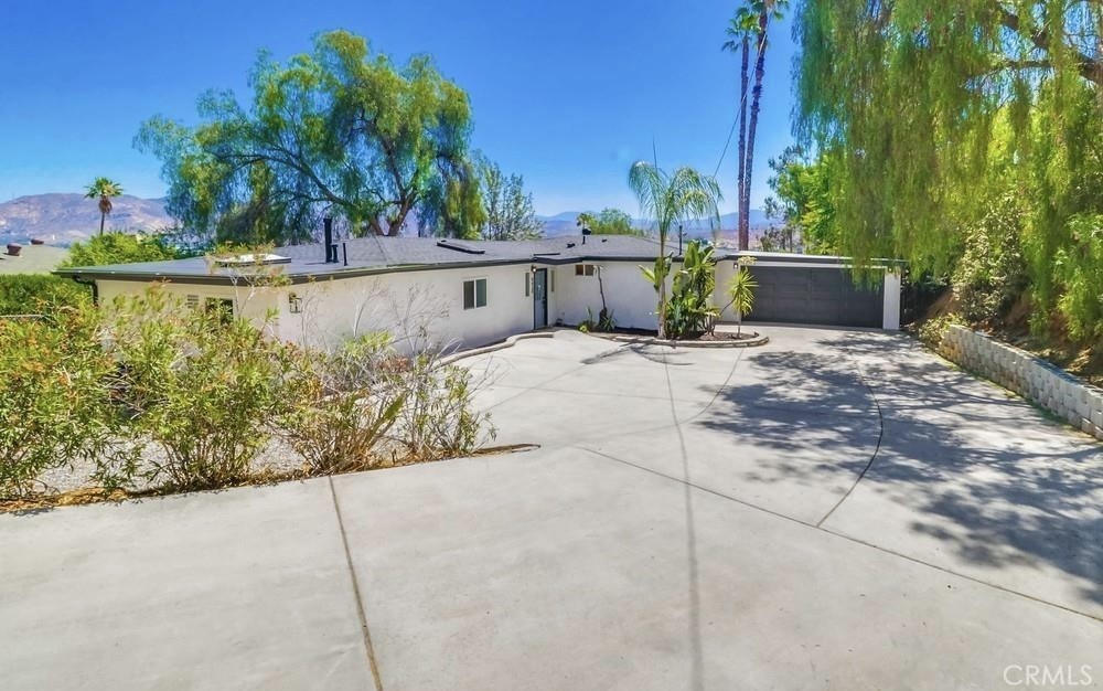 Epic Views. Elevated Living. Welcome to 9430 Riverview Avenue—perched on a private, elevated lot in the heart of Lakeside, this fully remodeled 3-bedroom, 2- bath home offers breathtaking panoramic mountain views from nearly every room. A long, gated driveway and pull-through carport provide ample space for your RV, boat, or desert toys—no HOA here! Step inside to a light-filled, open-concept layout designed for modern living and entertaining. The designer kitchen features an oversized 10’ island, sleek finishes, and uninterrupted flow into the spacious living and dining areas. Large windows and sliders frame the stunning mountain backdrop while flooding the home with natural light. Retreat to the luxurious 400 sq ft primary suite complete with dual walk-in closets and a spa-inspired bathroom featuring custom tile work and a frameless glass shower. Enjoy updated systems throughout: new roof, new furnace, new AC compressor, Nest thermostat, upgraded 200-amp electrical panel, LVP flooring, and a new gutter system. The large, flat backyard is a blank canvas—ready for your dream pool, garden, or ADU. Whether you’re looking for a serene retreat or an entertainer’s paradise, this home delivers both. Conveniently located with quick access to Hwy 67, Lake Jennings, and the charm of downtown Lakeside. Don’t miss your chance to own one of Lakeside’s most unique view properties—schedule your private tour today!