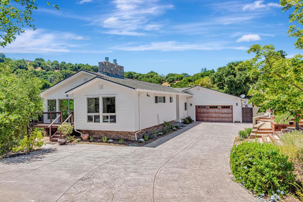 Welcome to this stunning Saratoga home, perfectly situated near the end of a cul-de-sac with astonishing views of the rolling hills. Minutes from the hustle and bustle, this beautiful home provides unbelievable privacy and tranquility. The well-appointed kitchen is a chef's dream, boasting granite countertops, an expansive island, and modern appliances including a dishwasher, microwave, and wine refrigerator. The open-concept design connects the kitchen to the family room and spacious deck, ideal for entertaining. Enjoy hardwood and tile flooring throughout, high and vaulted ceilings, and a cozy fireplace to enhance the ambiance. The home is equipped with central AC, solar panels, and advanced energy features like double pane windows and 4 solar power battery backups. Laundry is made convenient with both electricity and gas hookups inside the home. Additional amenities include a whole-house water softener system and multiple EV chargers and EV hookups on the property. The home has been well kept and is in move-in condition! The property is located within the award-winning Cupertino Union School District. It is close to H Mart, Trader Joe's, Safeway, 99 Ranch Market, and the Farmer's Market at De Anza College. Don't miss the opportunity to own this exceptional Saratoga home.