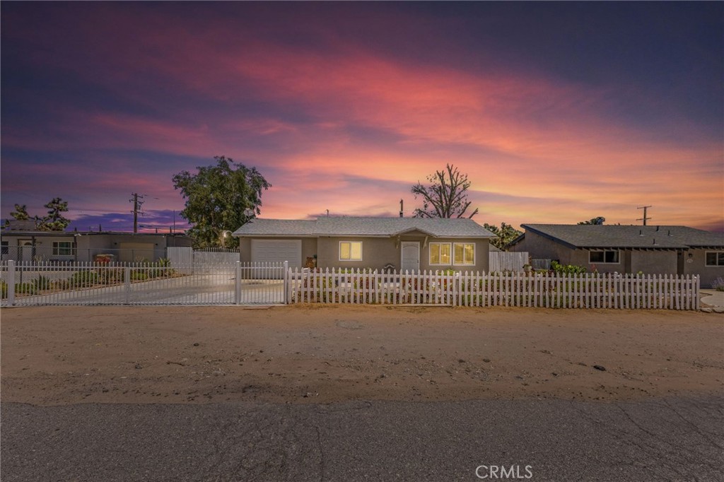 This charming 3-bedroom, 1.5-bath home is located in a quiet, established neighborhood. Enjoy a beautifully landscaped front yard with a fenced entry and a long concrete driveway — perfect for extra parking or RV potential. Inside, the home features tile flooring throughout, dual-pane windows, and a spacious indoor laundry/bonus room. The kitchen offers plenty of cabinet space, cherry oak finishes, and a modern backsplash. Step into a large backyard with a covered patio and mature trees — perfect for gatherings, kids, or your dream garden. Comfortable, clean, and move-in ready. Come see it for yourself!