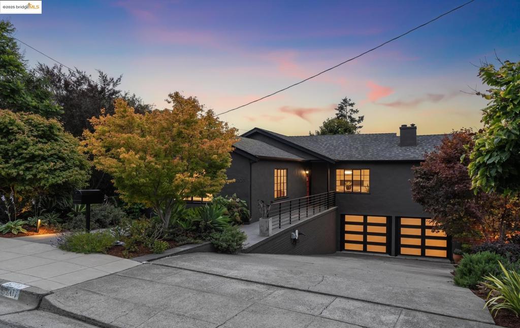 Tucked into the heart of Upper Rockridge, this thoughtfully updated 1938 gem serves up serious charm with a side of sunshine. The light-filled, mostly single-level beauty features a gracious living room with a stately fireplace and oversized windows framing lush garden views. The stylish kitchen is a standout, with rich cabinetry, double wall ovens, generous counter space, and a breakfast bar perfect for coffee, snacks, or catching up with friends. A sweet Dutch door leads to a spacious teak deck with views of the yard, city, and Bay—ideal for morning lattes or sunset dinners. Three bedrooms on the main level include an ensuite with walk-in shower, one with San Francisco views, and two overlooking the garden. Downstairs, a private suite offers spa vibes, a walk-in closet, and access to the backyard—use it as a dreamy primary, guest space, or chill zone. Outside, find broad patios, mature trees, and even a hidden fort and swings under the deck. Bonus: a reimagined 600+ sq ft garage ready for your gym, studio, or office, plus a laundry zone with wet bar + waterfall island. EV charger included! Close to Hillcrest, Montclair, Rockridge, BART & parks—this home is ready to make every day feel special.