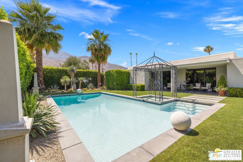 BOLD MODERN DESIGN meets ultimate privacy in this 3-bedroom plus office, 3.5-bath contemporary home in South Palm Springs. Located in the highly coveted Canyon South 5 community, this stunning property on land you own offers panoramic mountain views, a private south-facing pool and spa, and meticulously designed outdoor spaces that make a statement. The home's striking architecture features a gated entrance, leading into a sleek, open-plan interior with clean lines, high ceilings, and expansive windows that flood the space with natural light. The gourmet kitchen is a chef's dream, complete with a large island, Bosch, Sub-Zero, and Wolf appliances, and flows seamlessly into the dining and living areas. Multiple sliding glass doors invite the outdoors in, creating an effortless transition to the private backyard, where a pool, spa, custom fireplace, and desert-inspired landscaping await. The formal living and dining areas are designed to impress, with a gas fireplace and direct access to both the south and east-facing yards, further enhancing the home's indoor-outdoor flow. The primary suite offers a peaceful retreat with mountain views, backyard access, and a spa-like bath with dual vanities, a large walk-in shower, and a spacious walk-in closet with custom built-ins. Two additional junior suites, each with private baths and direct access to the outdoors, provide the perfect balance of comfort and flexibility. An office off the main living area opens to the patio and completes the picture, offering both privacy and functionality. Canyon South 5's community amenities include two pools, spas, tennis and pickleball courts, and beautifully manicured grounds, providing everything you need for an elevated Palm Springs lifestyle.